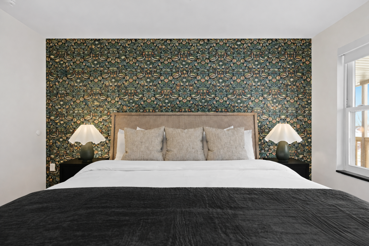 Elegant bedroom with a plush bed, warm bedside lighting, and a stunning accent wall—creating a cozy, boutique-style retreat for restful nights.