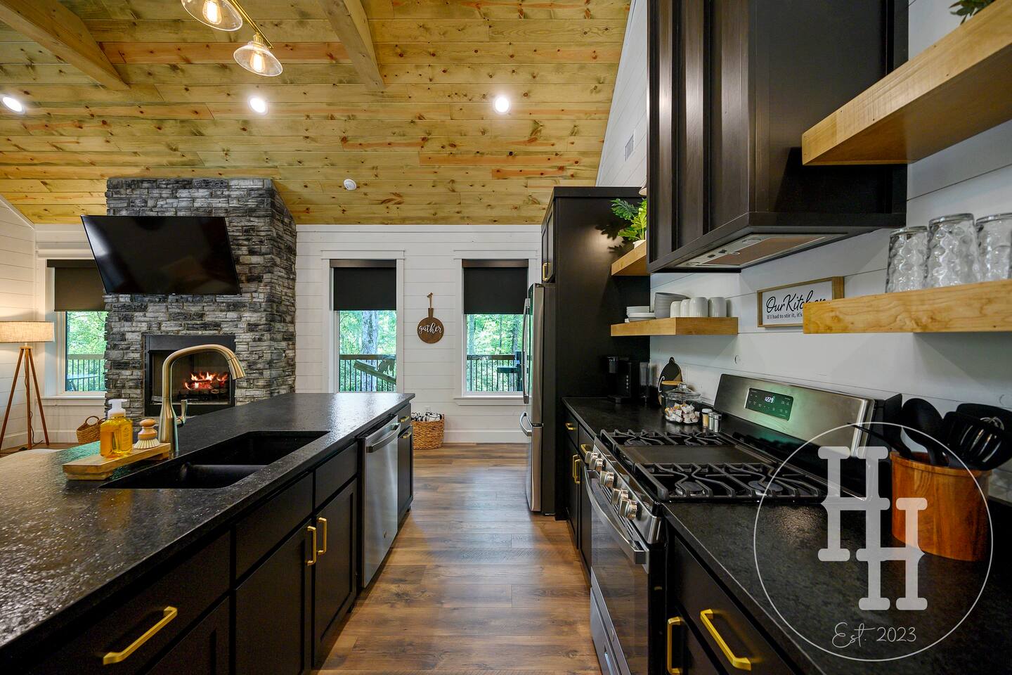 Kitchen is stocked with serving spoons, knife block, can opener, measuring cups