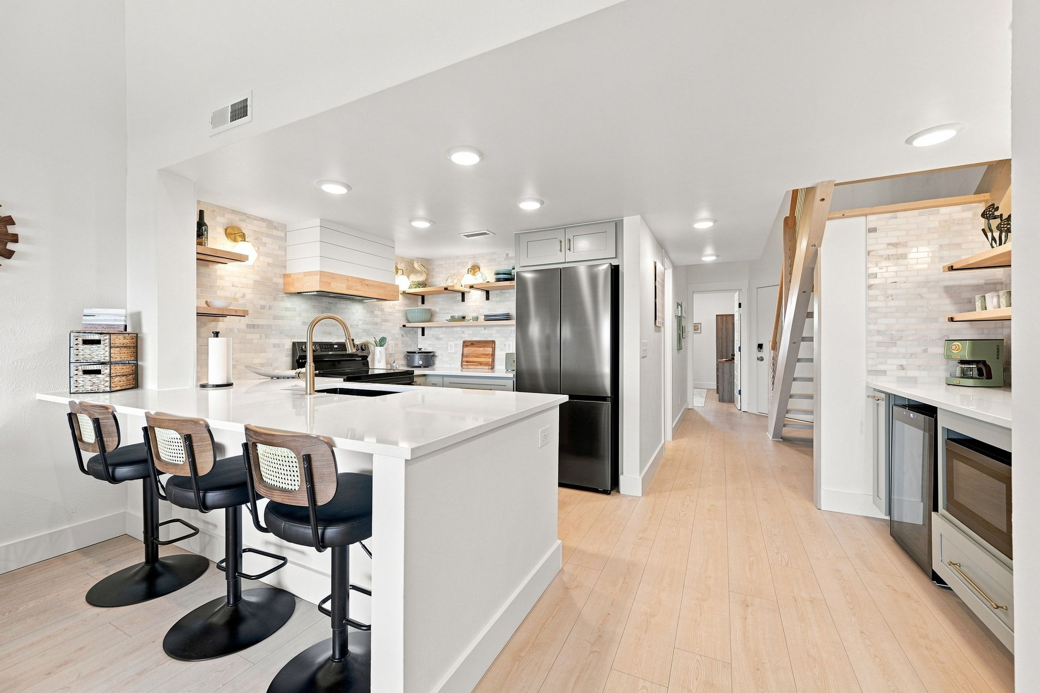 A spacious, modern kitchen where functionality meets relaxed coastal style.
