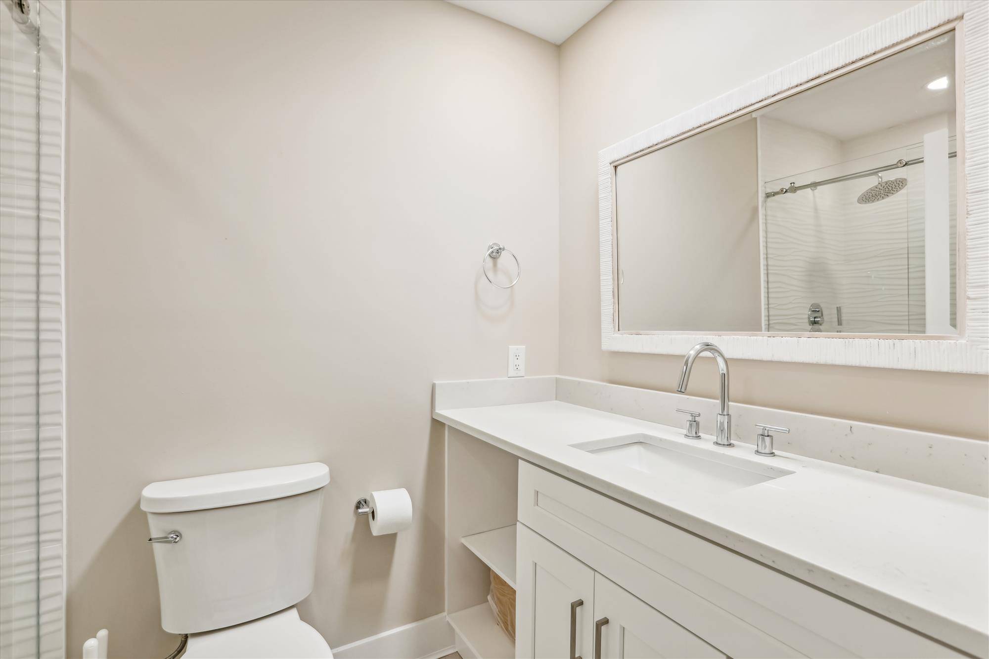 Bathroom for second bedroom features a walk-in shower