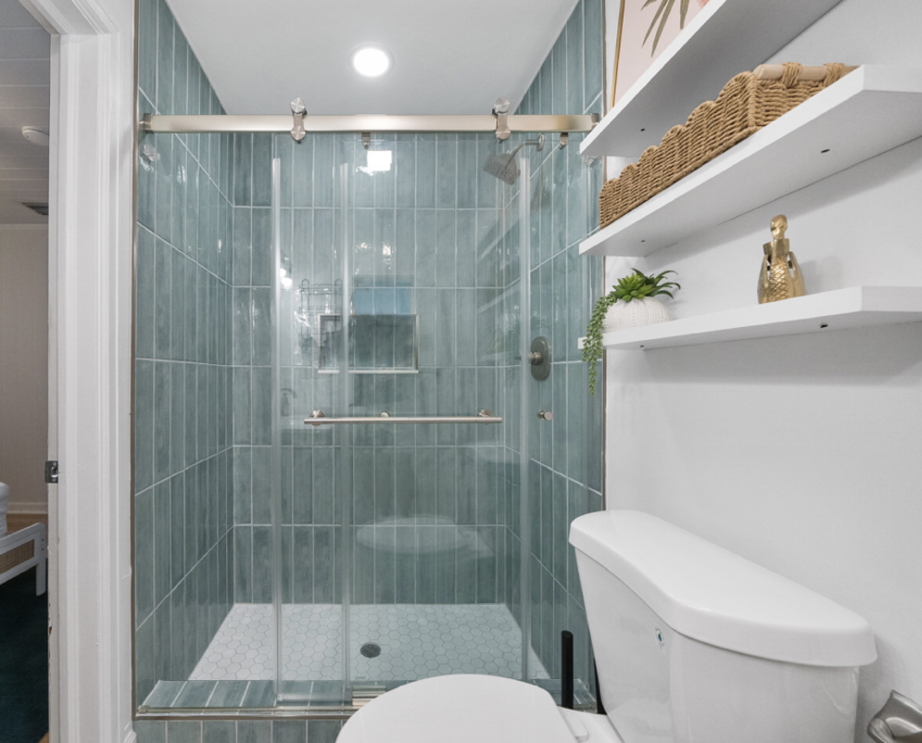 Bathroom #1, Jack and Jill — the new walk-in shower with seafoam tile, glass doors, and built-in shelves