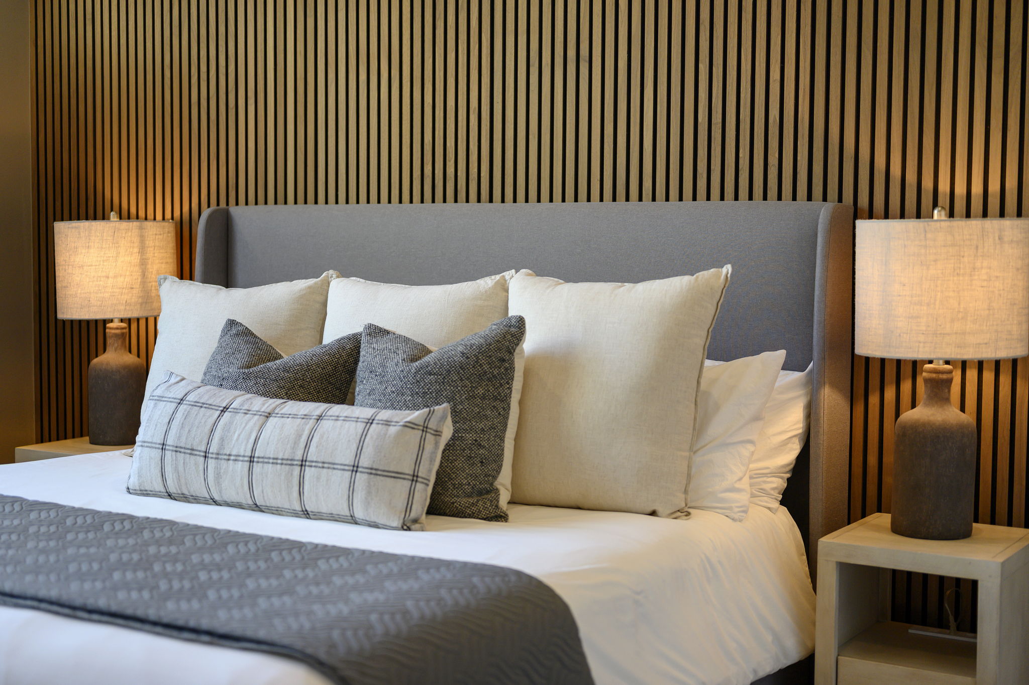 King Suite 2 - Large and spacious suite with teak wood paneling, designer finishes, smart TV, premium king mattress, and luxury bedding. Includes stunning views of the hardwood forest. 