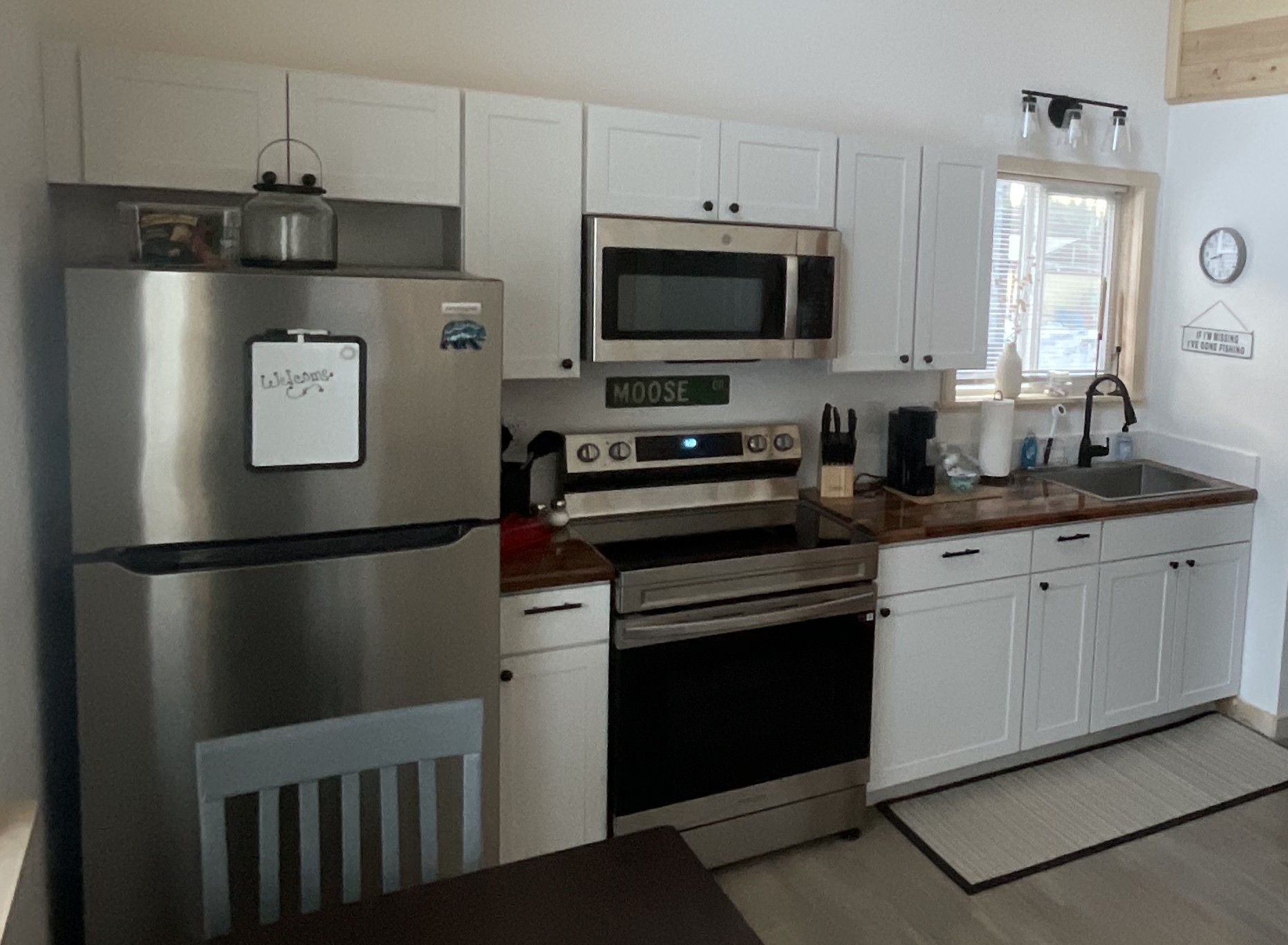 Kitchen includes an electric range, microwave, refrigerator, and Keurig.