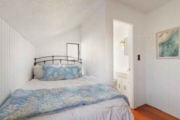 The Snug’ bedroom: full bed with its own half bath, ideal for quiet, private stays.