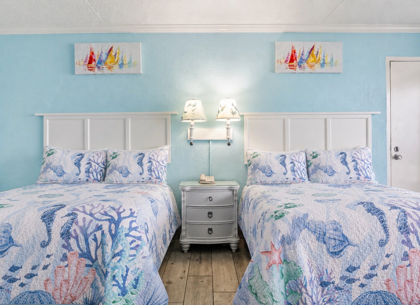Two beds, twin reading lamps, and a nightstand made for late-night chats. ⭐