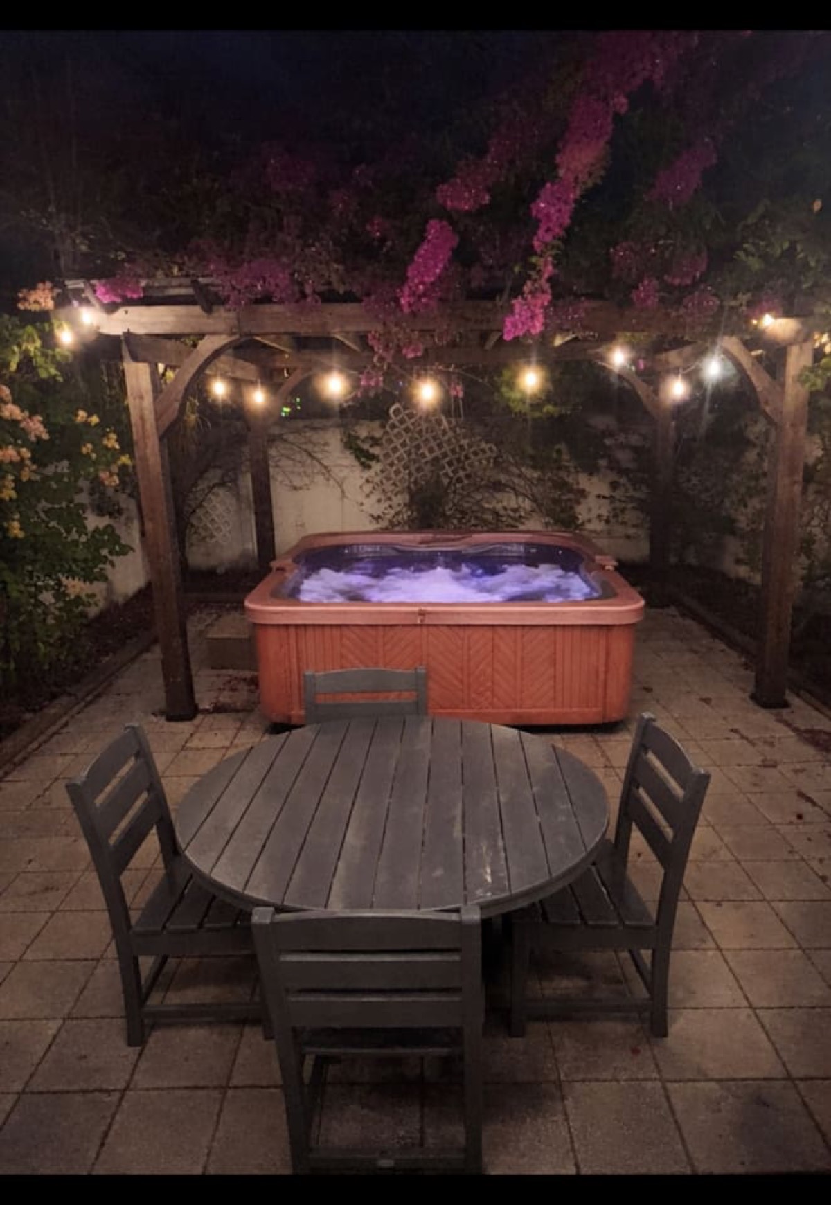 Evening hot-tub retreat under bougainvillea and string lights. “No place we’ve ever stayed has been quite as delightful as the Ybor Roost. One of a kind!” — Guest review
