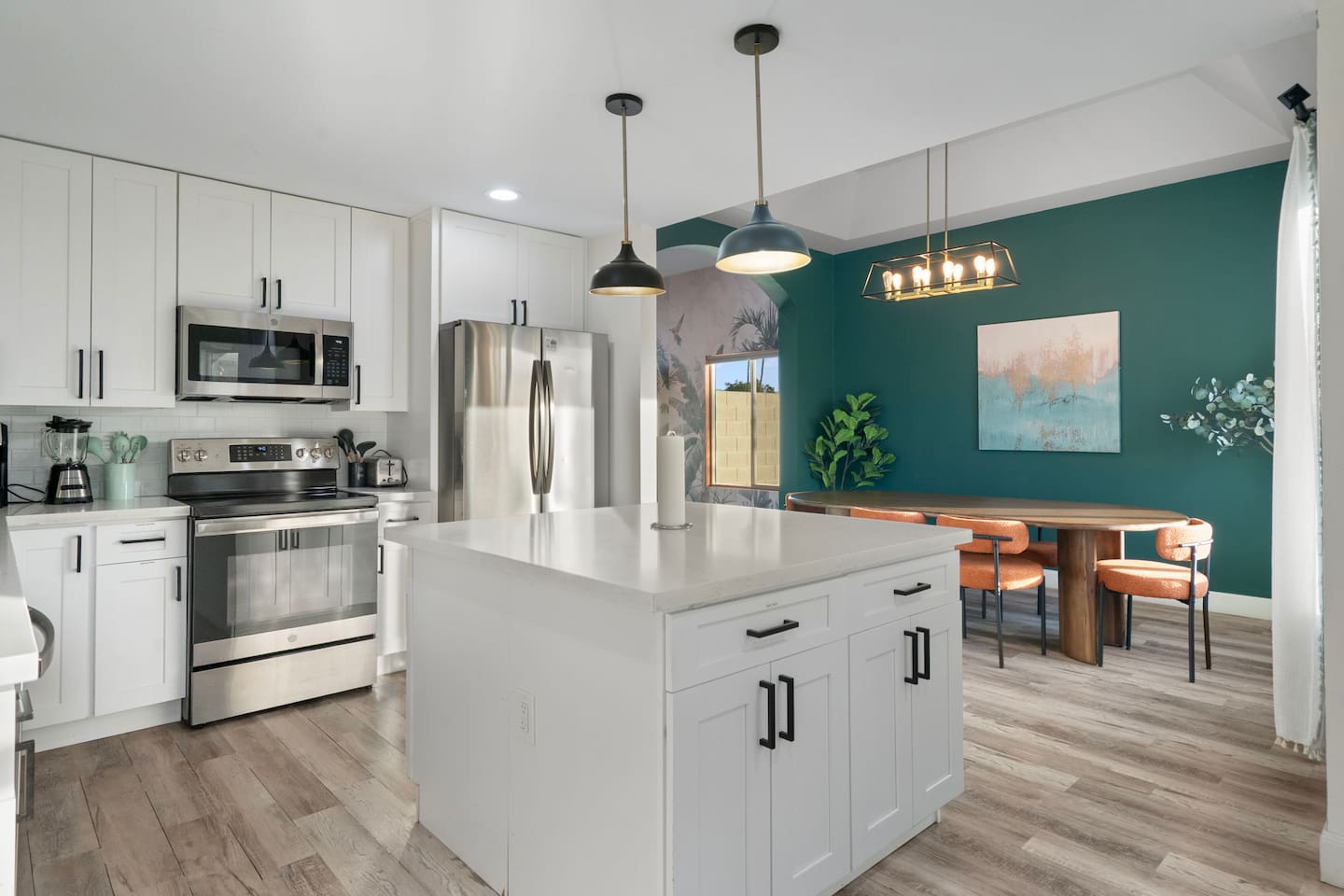 Culinary style meets designer flair, with a striking dining space just beyond.
