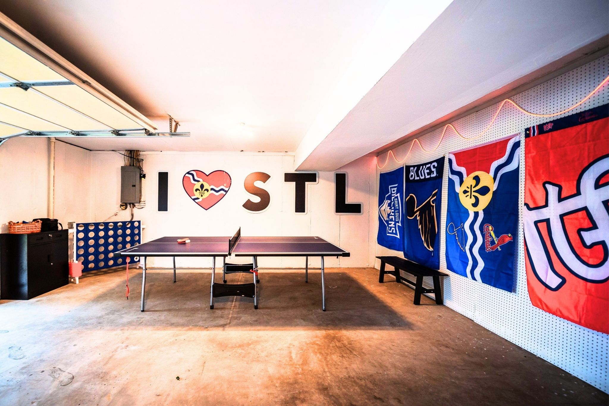 The garage doubles as an oversized game room with ping pong, cornhole, and more.
