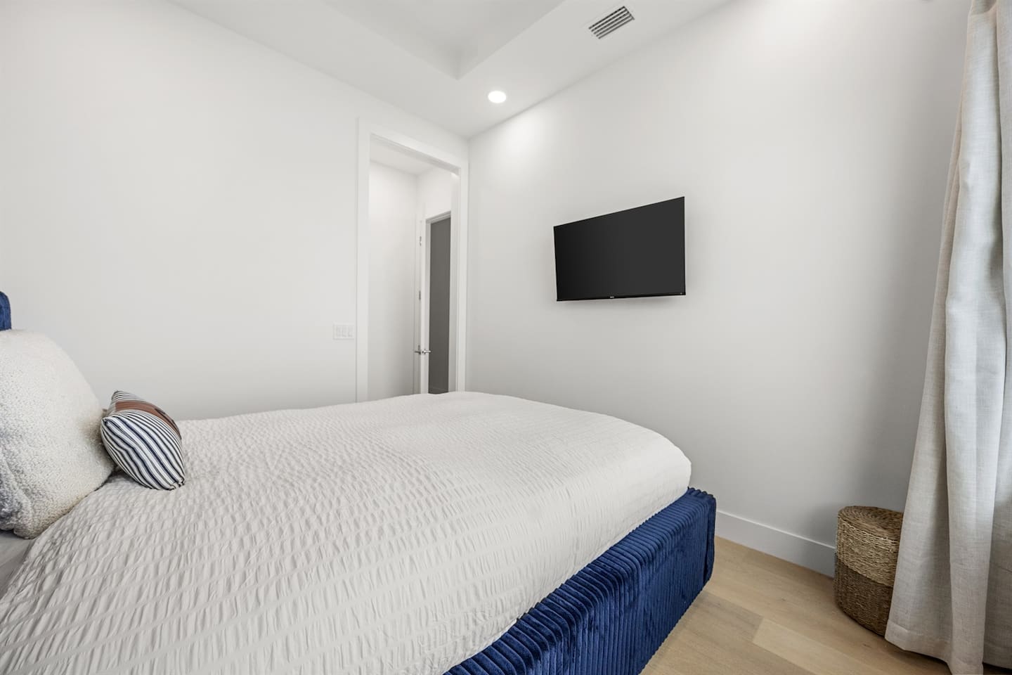 This bedroom features a TV, providing a comfortable space for relaxation and entertainment at the end of the day.