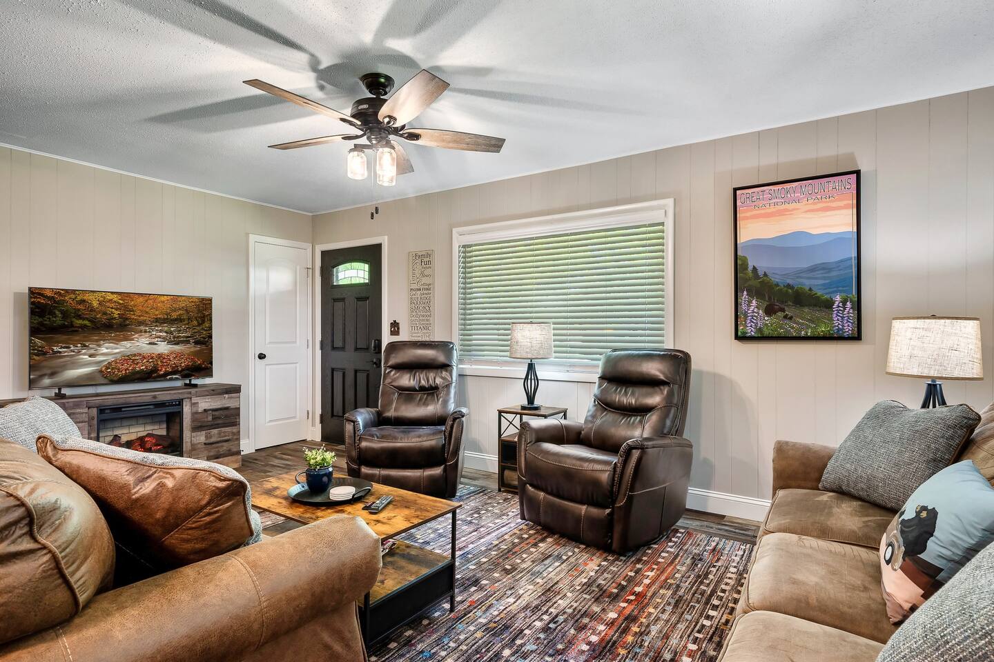 Share stories, laughter, and memories in the heart of the home – the spacious living room, featuring an electric fireplace and inviting recliners. #FamilyTime