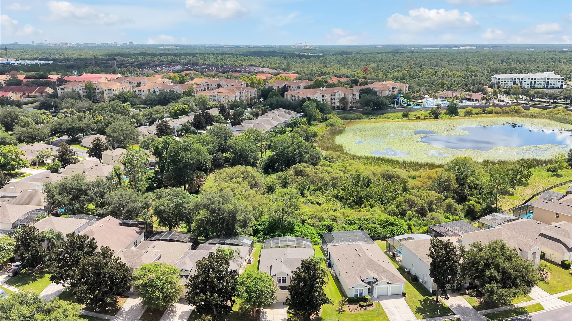 Motunui Villa Aerial: Motunui Villa backs onto peaceful conservation, with Reedy Lake and the Windsor Hills clubhouse and waterpark visible beyond.