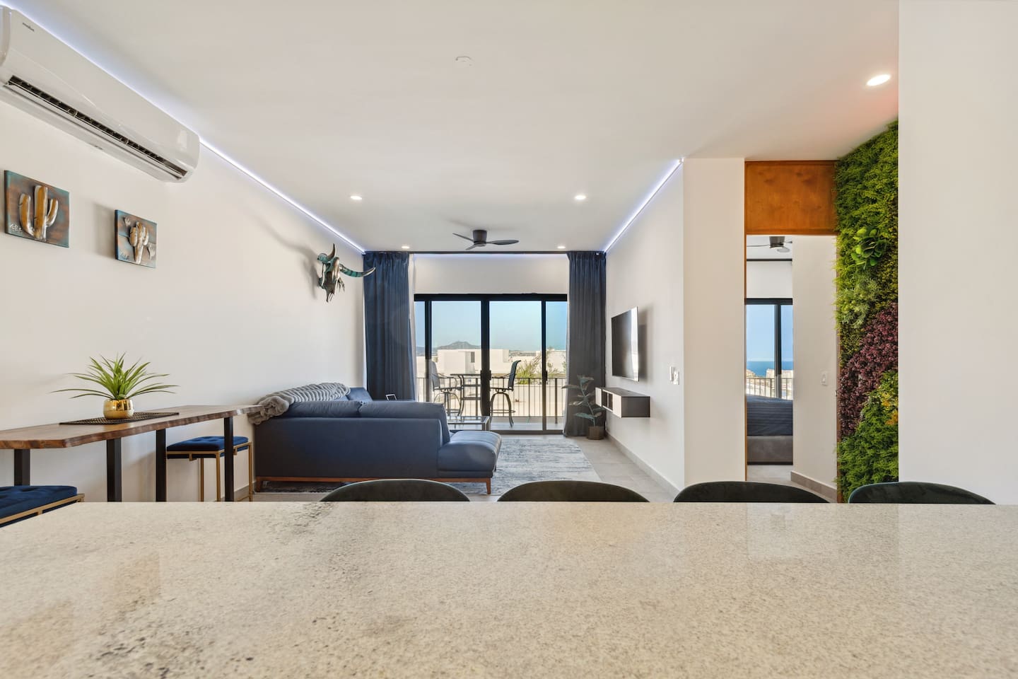 View from the kitchen bar into the living room and master bedroom.