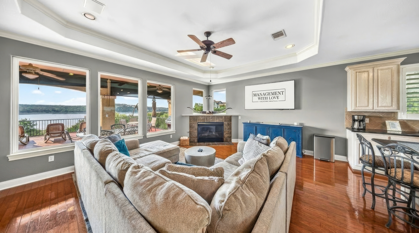 A living room with a 75-inch TV in an open concept design, offering a view. 