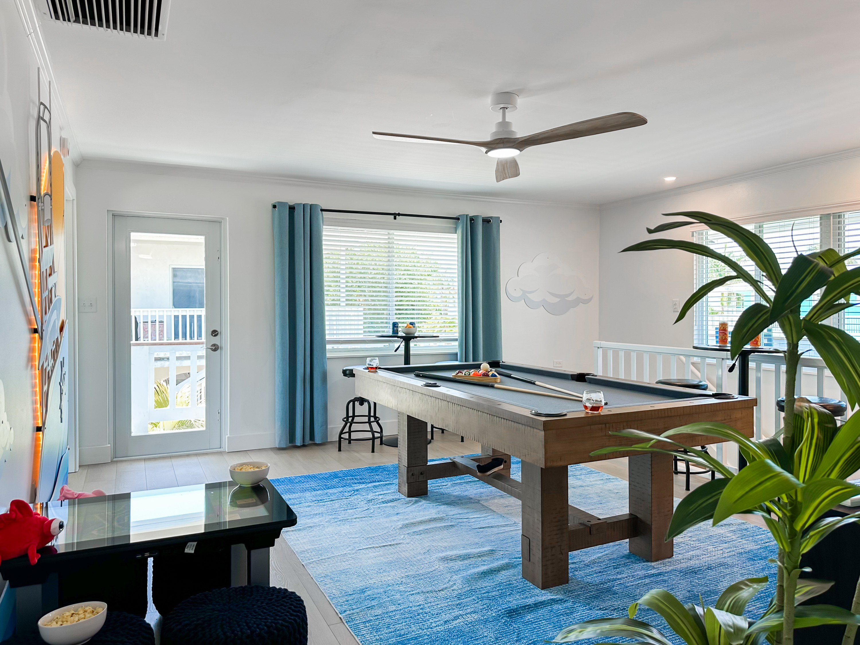 The stairs lead you up to the second game room where you can play a round on the pool table.