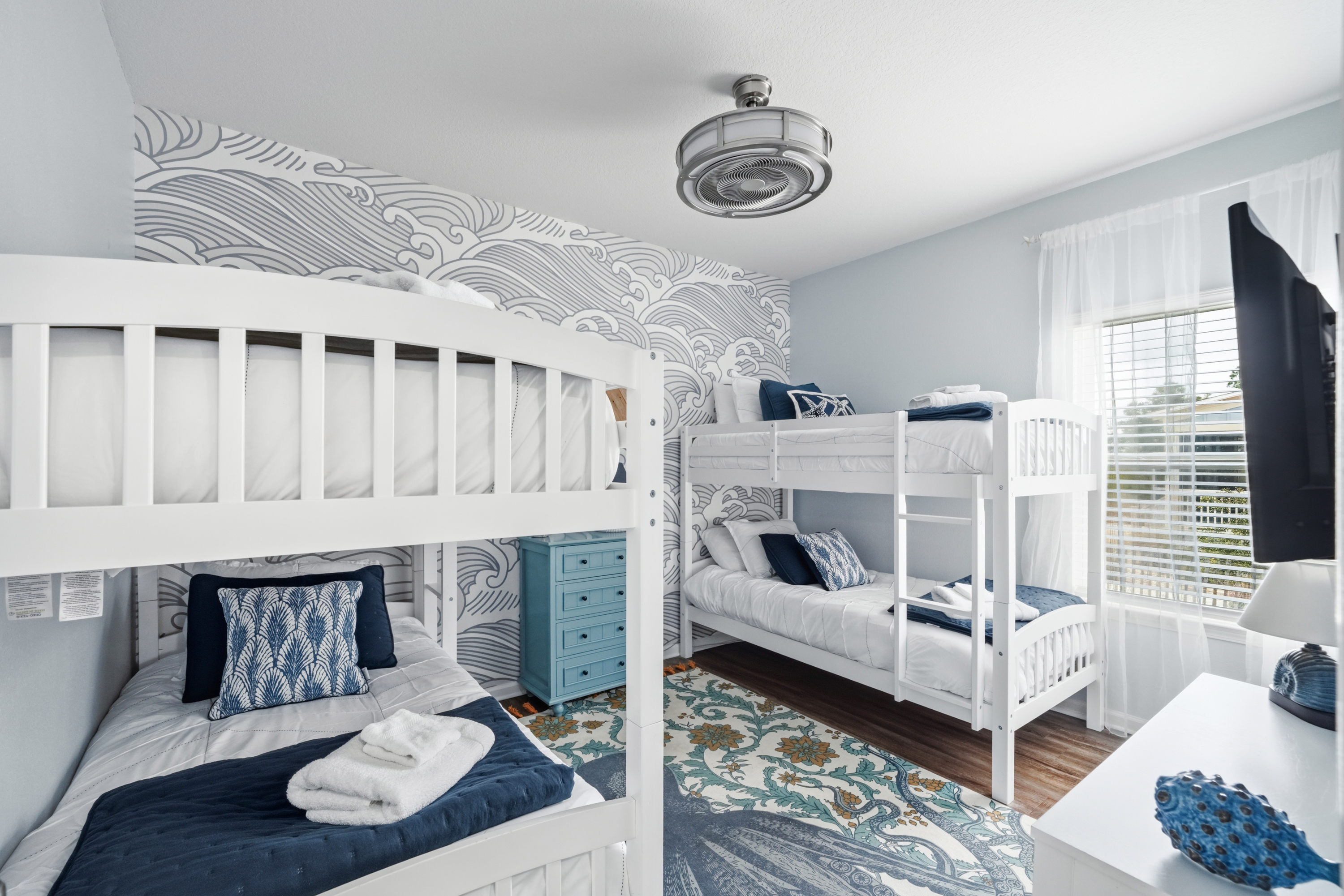 Cozy twin bunk beds provide a comfortable and playful space where kids and friends can relax after a day at the beach