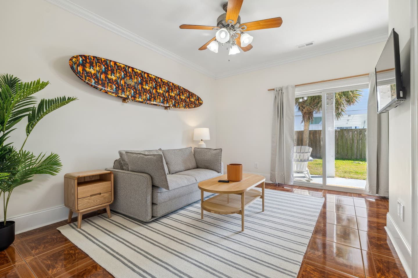 This room is located on the ground level, at the back of the home and functions as an extra living space with a tv, and also a bedroom with a private bathroom. This room also allows access to the backyard area. The sofa is a pullout.