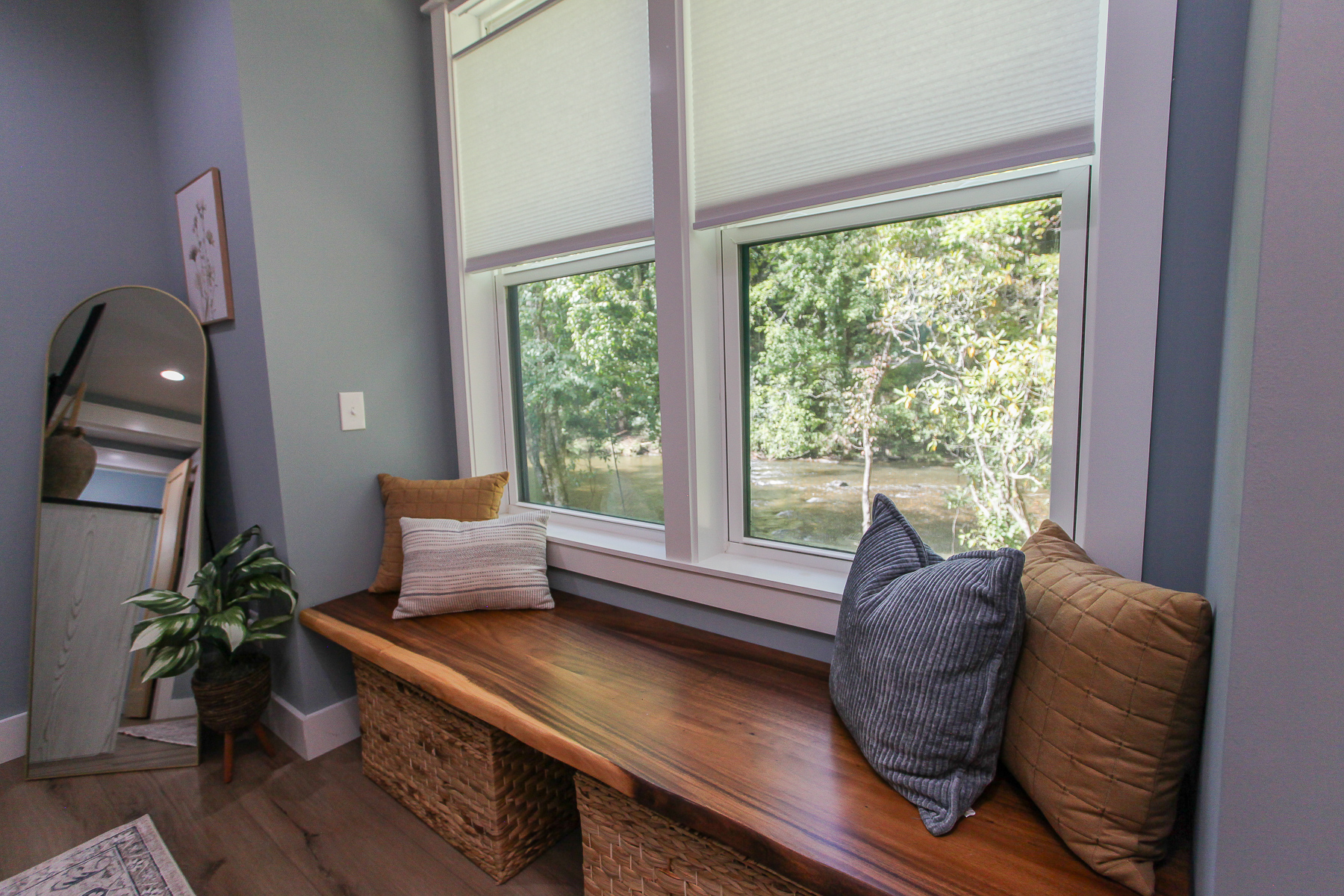 Enjoy a quiet moment on the primary bedroom’s window bench, overlooking the water at Robbin’s Nest on Snowbird Creek.