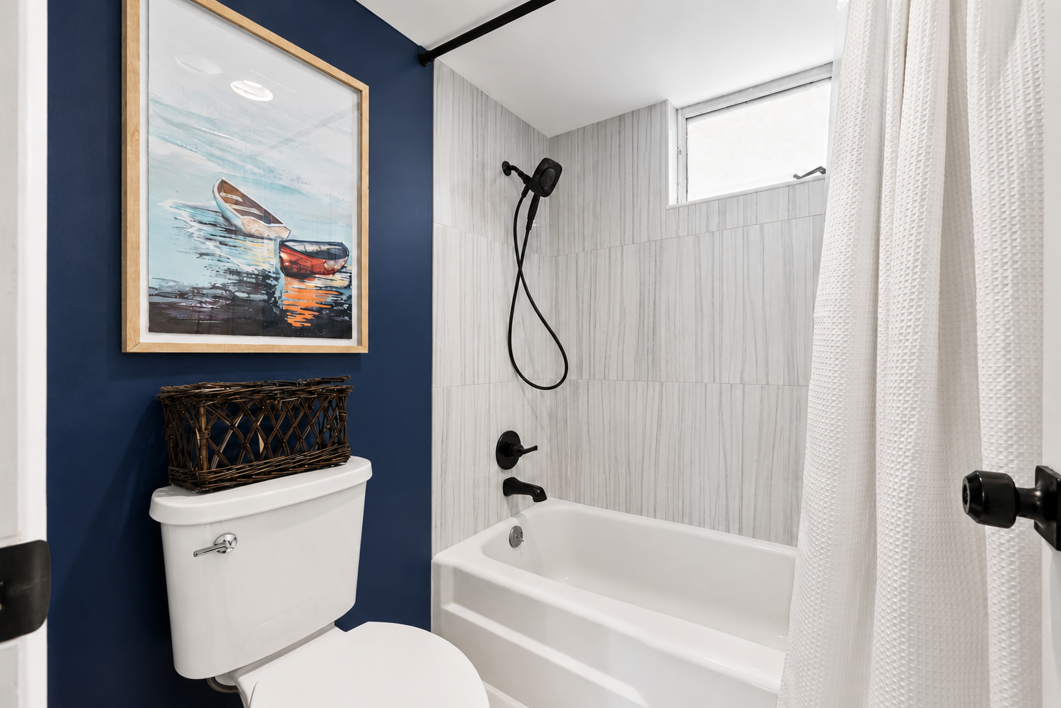 Second bathroom featuring a bathtub and shower.