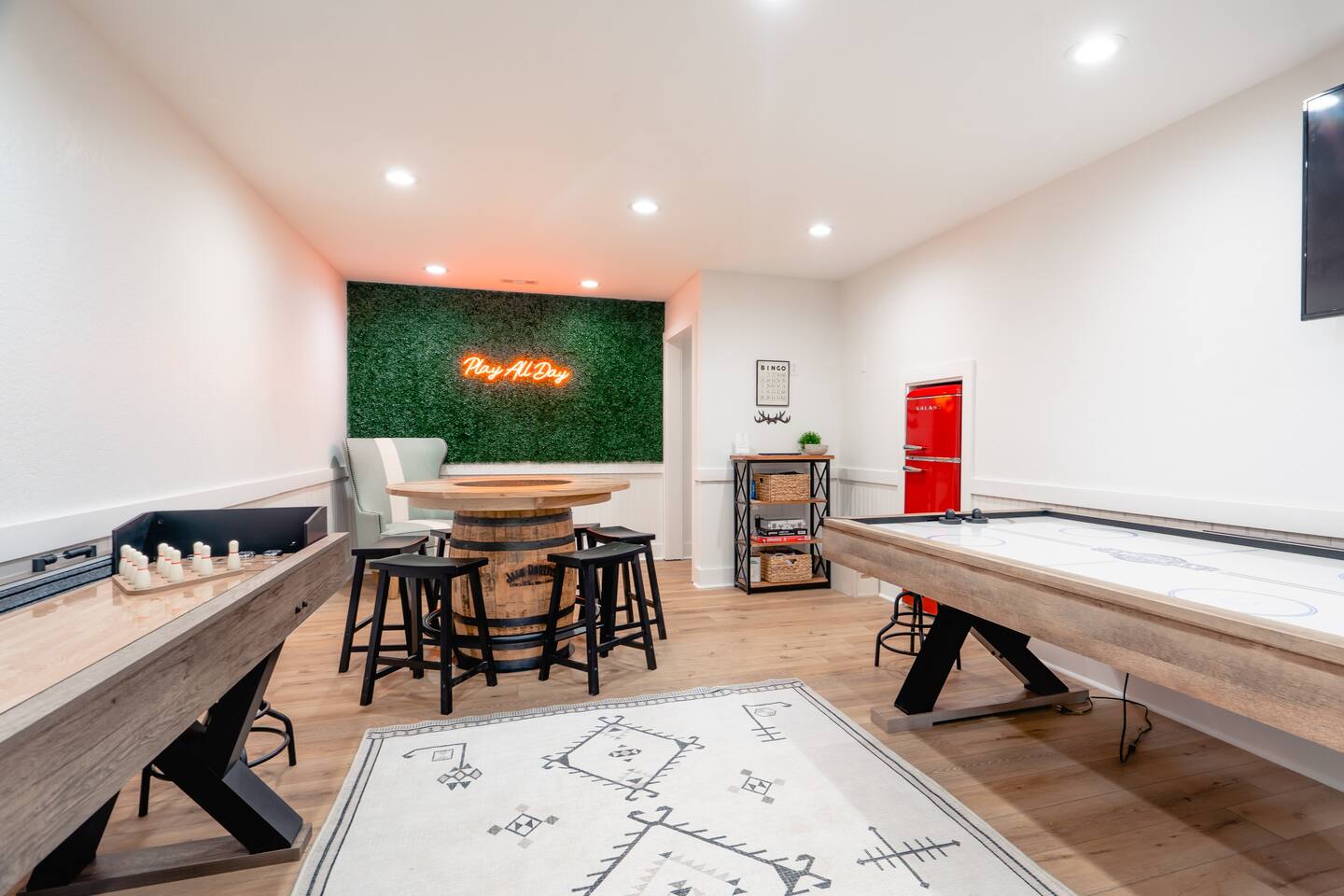 Game room with air hockey, shuffle board, arcade set, and foosball