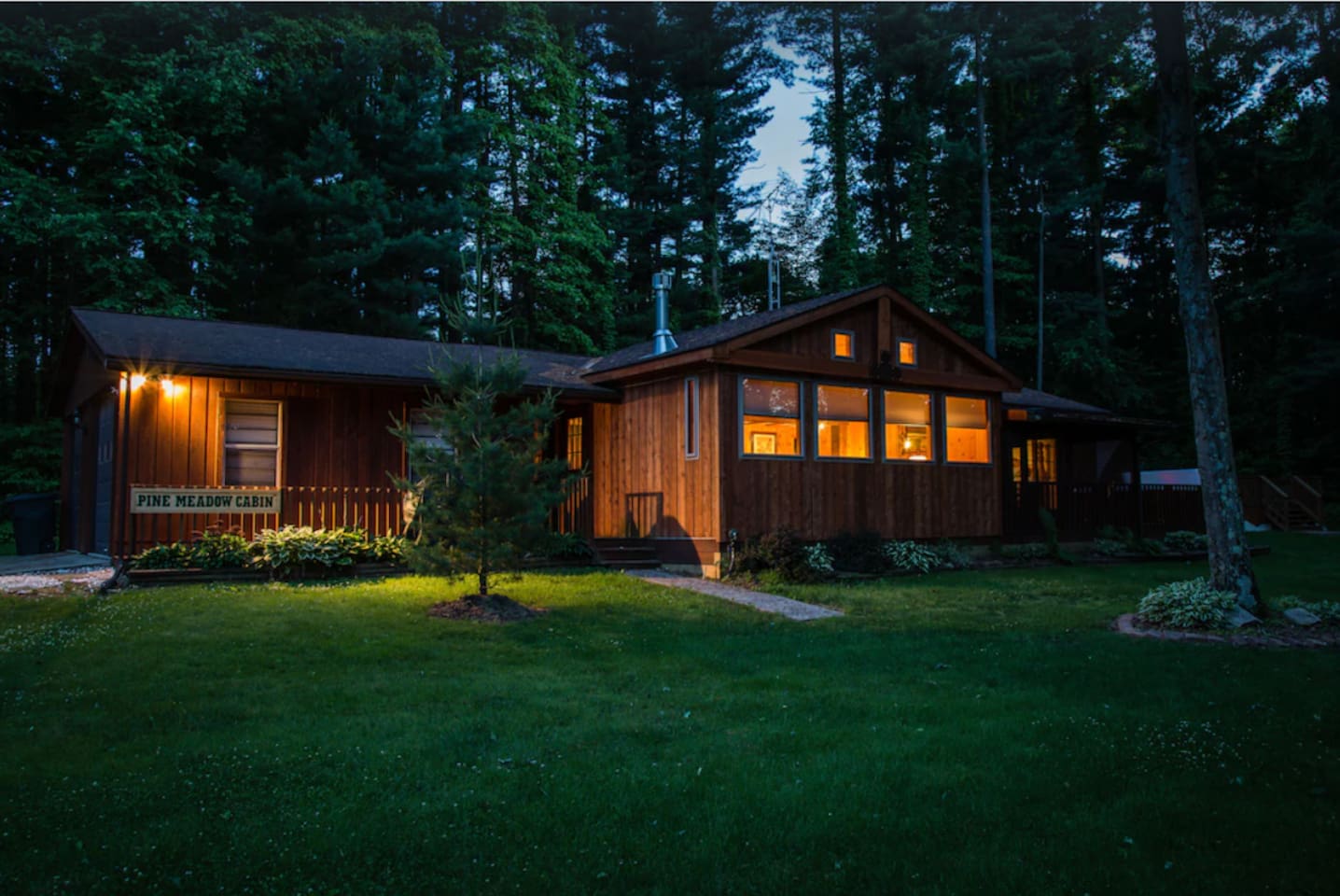 Serene view of Pine Meadow Cabin at night. 