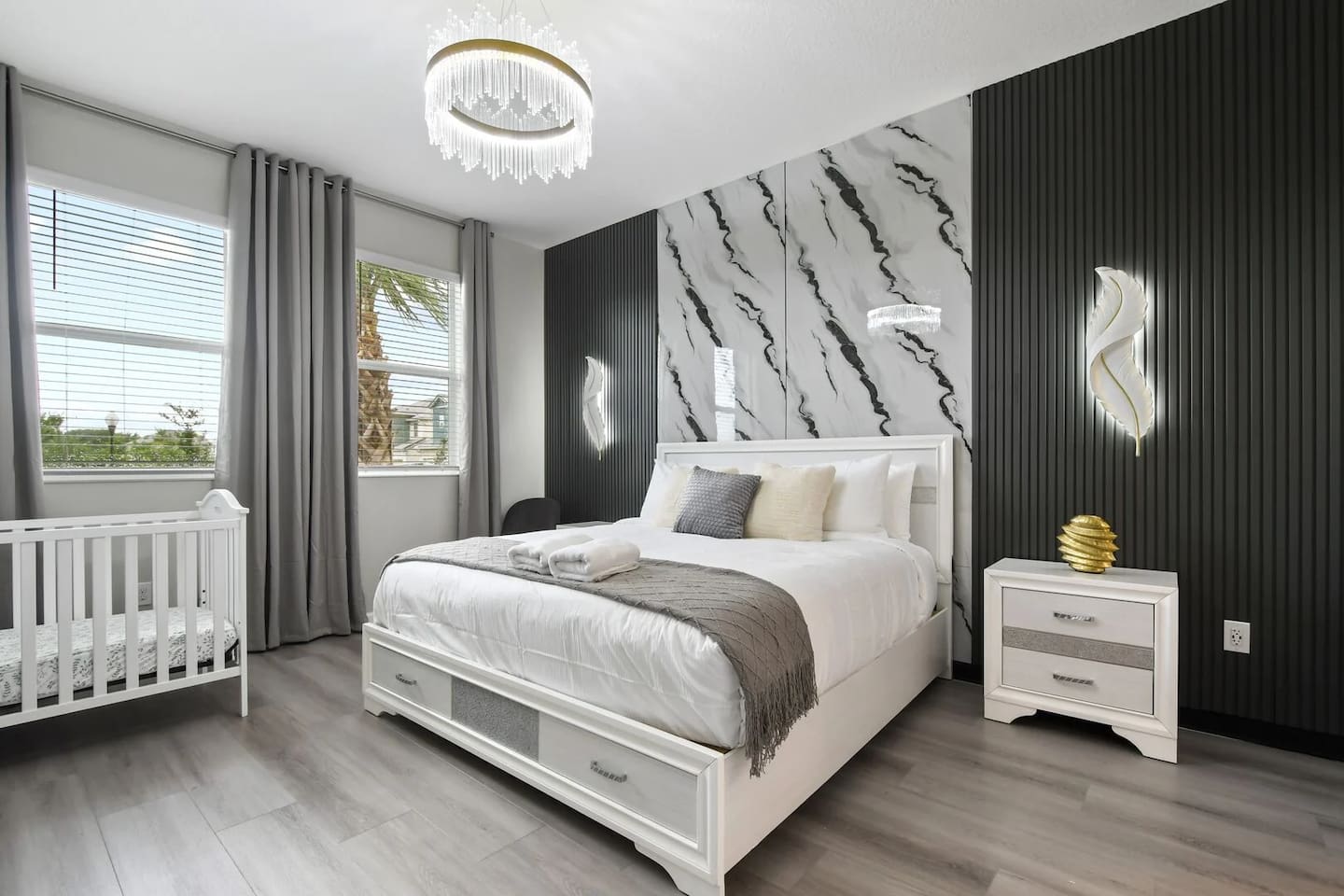 Elegance meets family comfort: A luxury king bedroom with a stylish custom crib for the little one