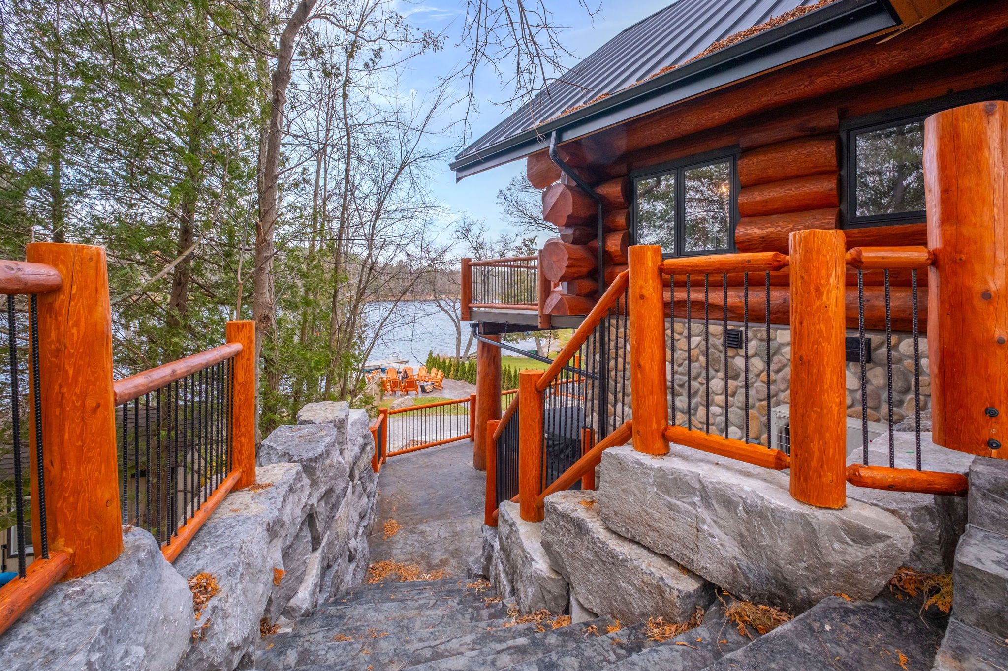 Stone pathway leading from the lodge to the waterfront firepit and dock — beautifully landscaped and illuminated.