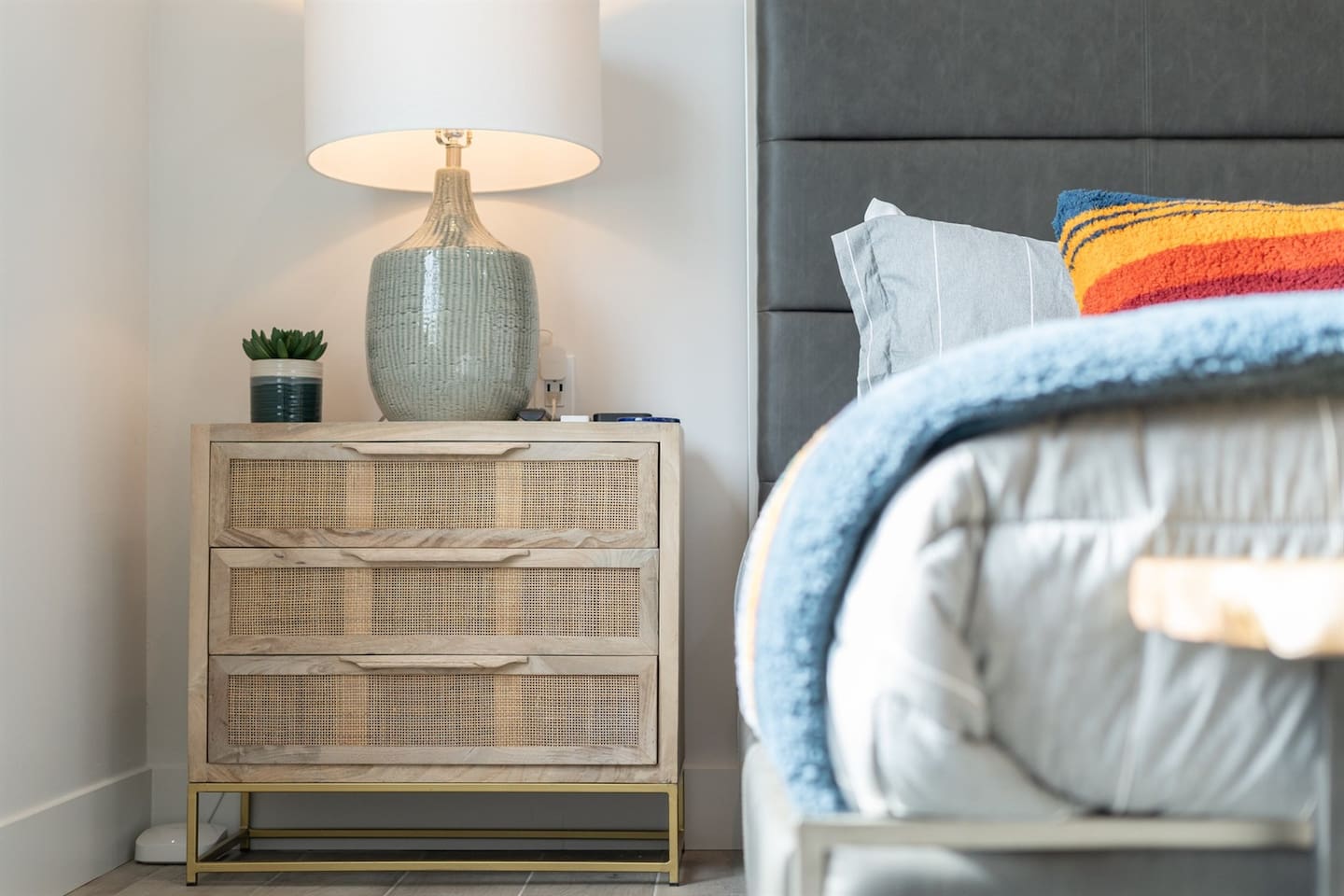 Enjoy a restful stay in this inviting king bedroom with large windows, elegant decor, and a ceiling fan. Watch TV from the comfort of soft sheets and plush pillows.