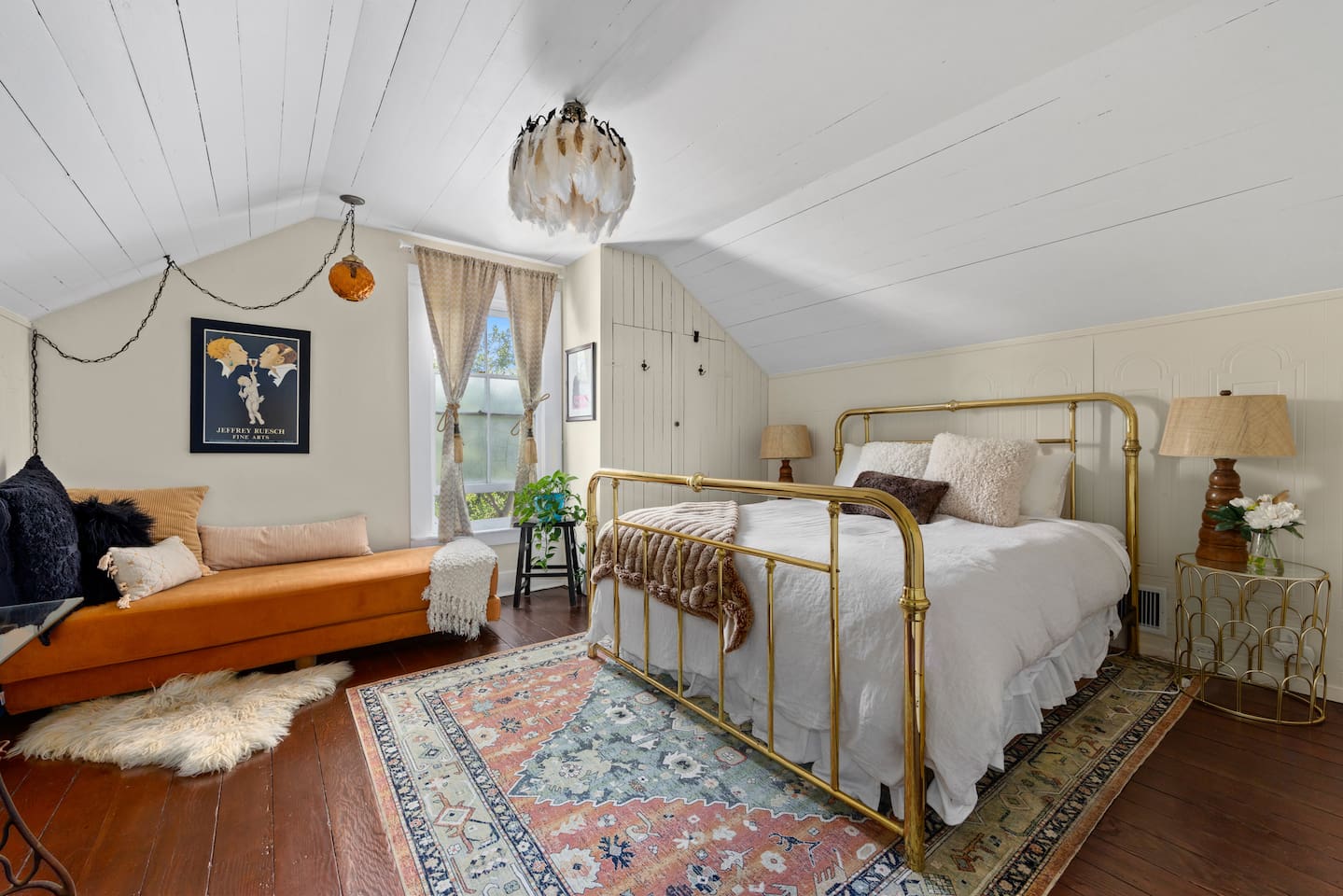 The Gatsby Bedroom brings a touch of 1920s glamour upstairs, with a gleaming brass bed, playful vintage-inspired lighting and a large Smart TV. The jewel-toned daybed converts to a full-size bed; extra linens await in the closet.