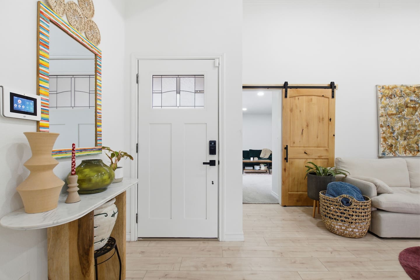 Welcome to your Dallas Getaway! Entry into the contemporary living room featuring a Smart TV with streaming, spacious sectional seating, high ceilings, and open-concept design for comfort and connection.