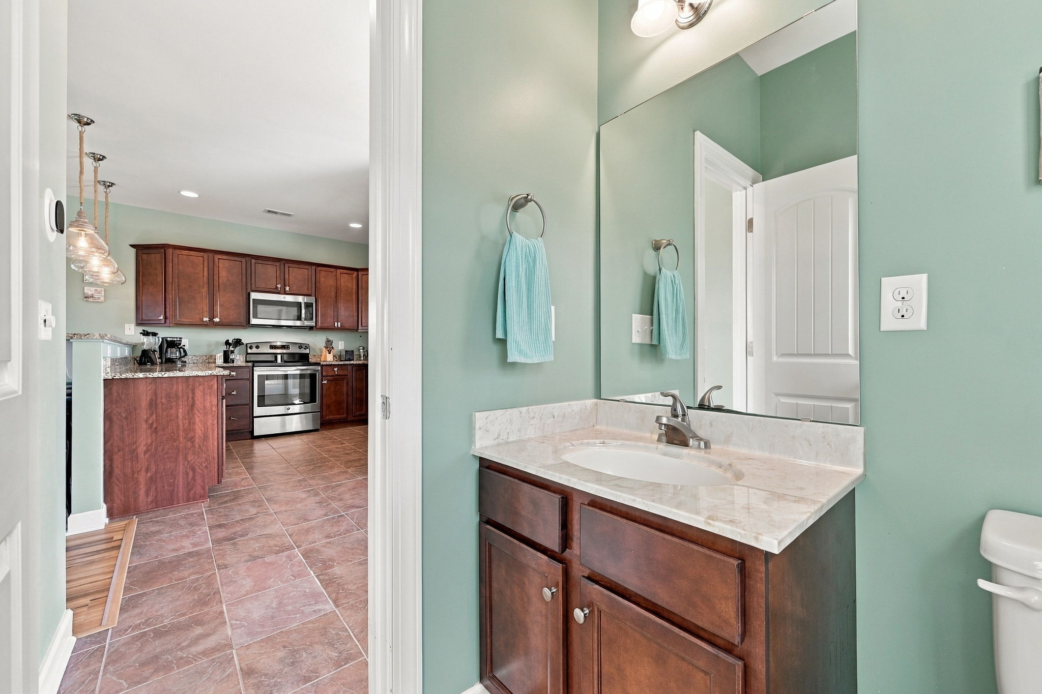 Convenient half bathroom located just off the kitchen and main living area