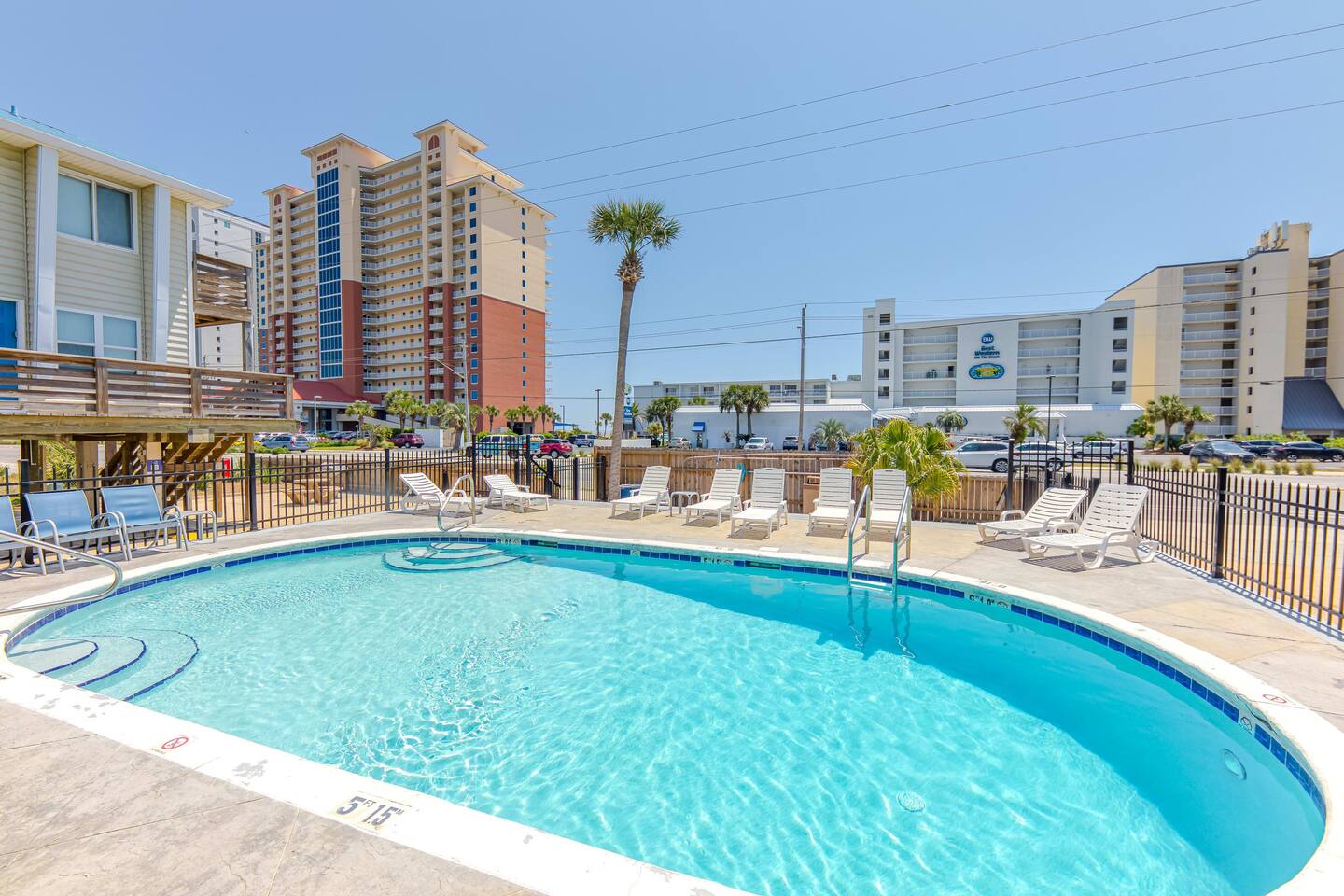 Poolside Retreat: Dive into relaxation at our sunny pool, surrounded by palm trees and fun!