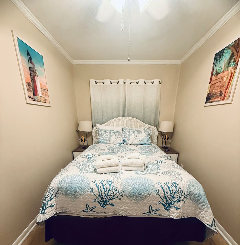 Queen bed with coastal bedding
