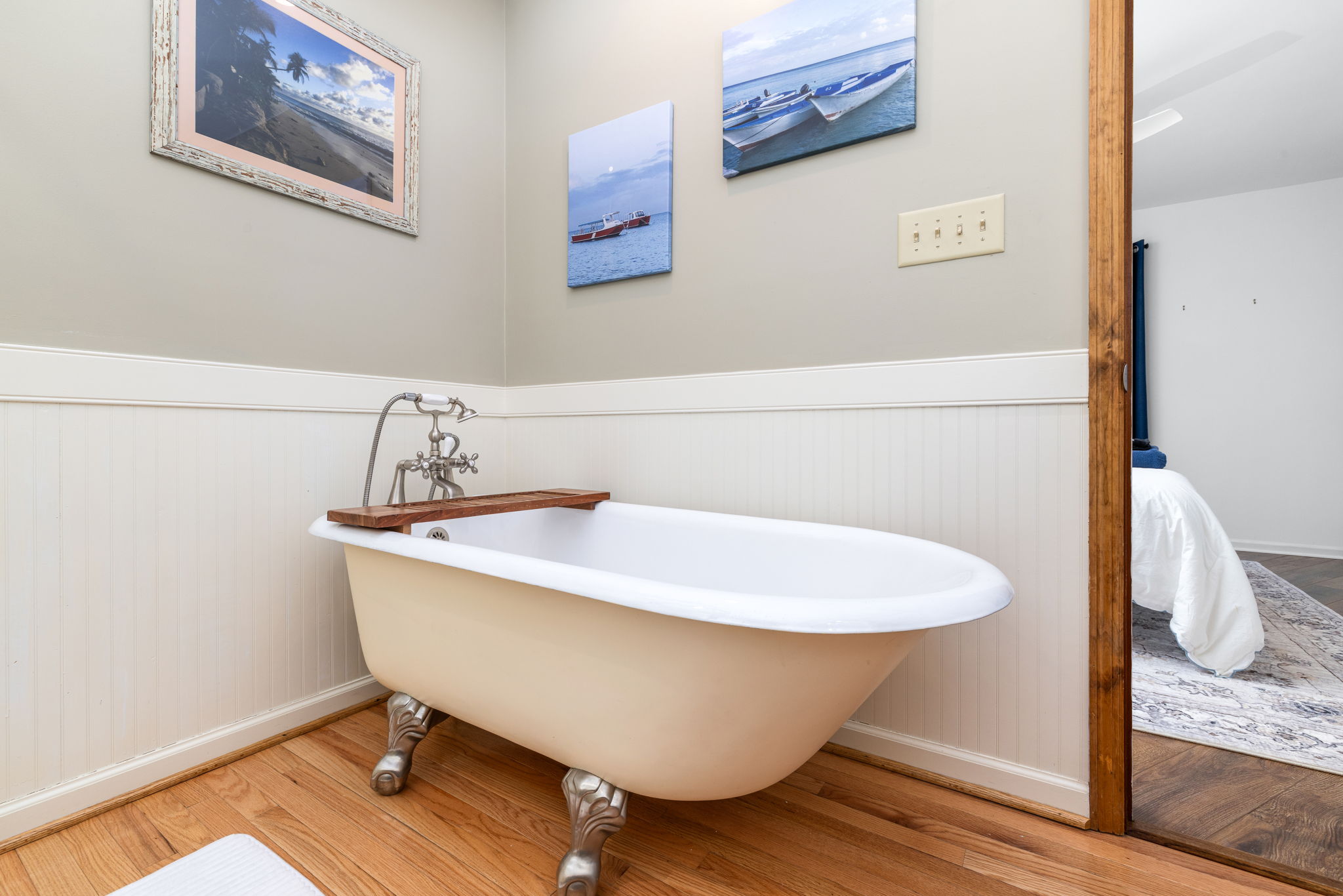 Bathroom Retreat: Unwind in a charming clawfoot tub surrounded by coastal decor!