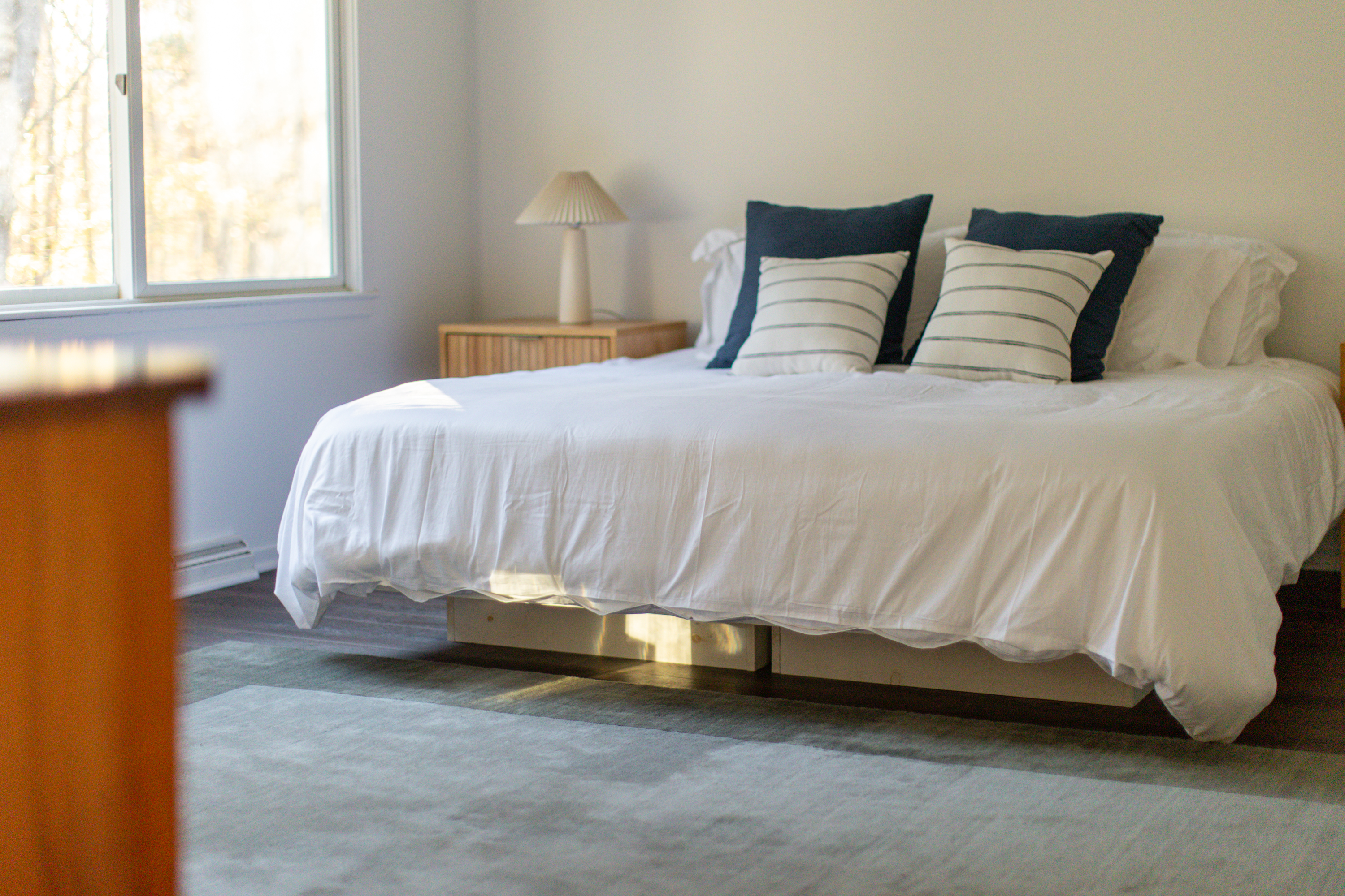 Primary Bedroom: Bright space featuring a comfy bed and lovely nature views. Perfect for relaxation!