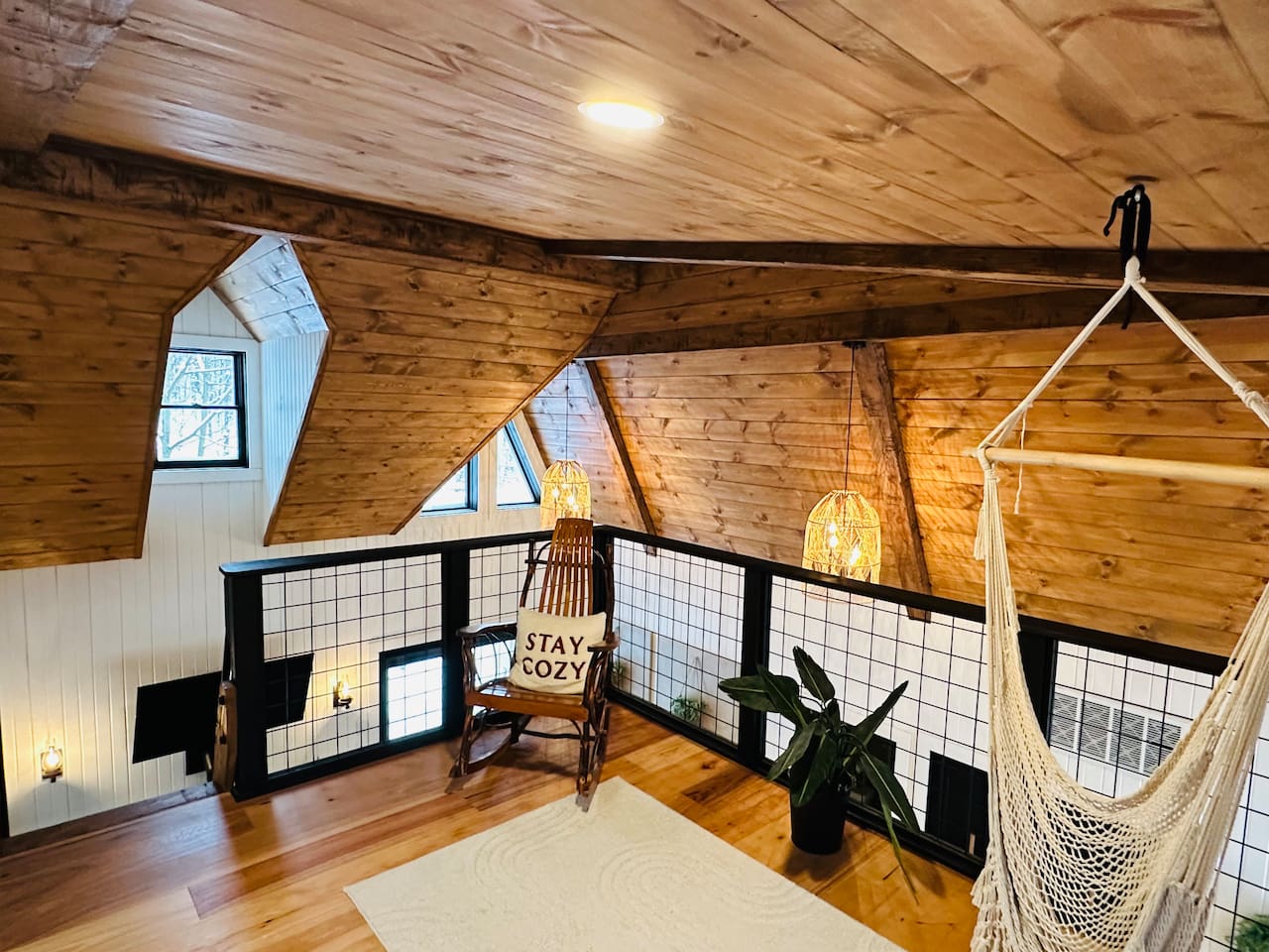 This cozy, open loft features a comfortable queen pullout sofa bed, perfect for two people. The loft overlooks the living room, offering a unique blend of privacy and openness, ideal for those who enjoy a spacious and airy living environment.