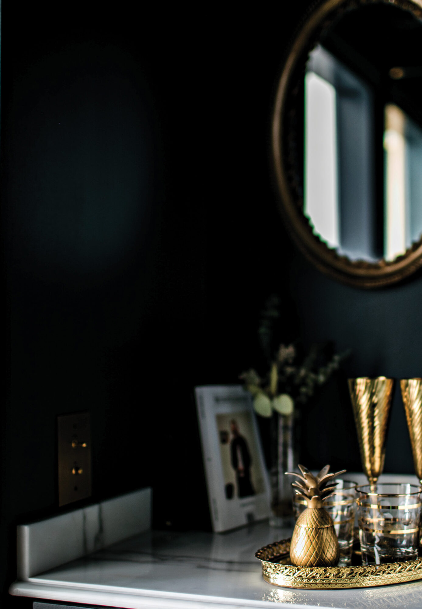 Curated lobby art — gold decanter detail near vintage mirror