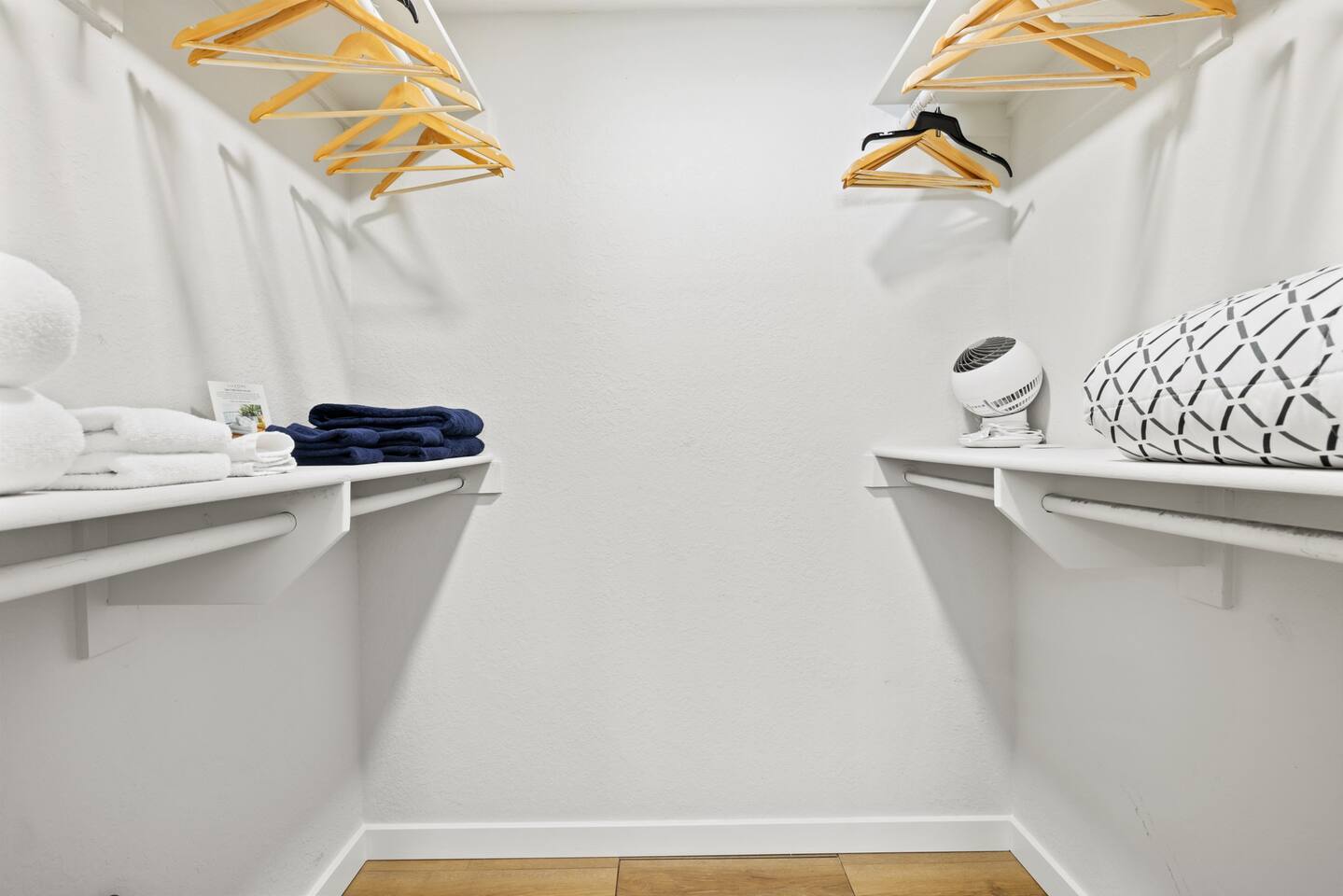 Primary closet stores extra blanket, fan and luxury bath towels