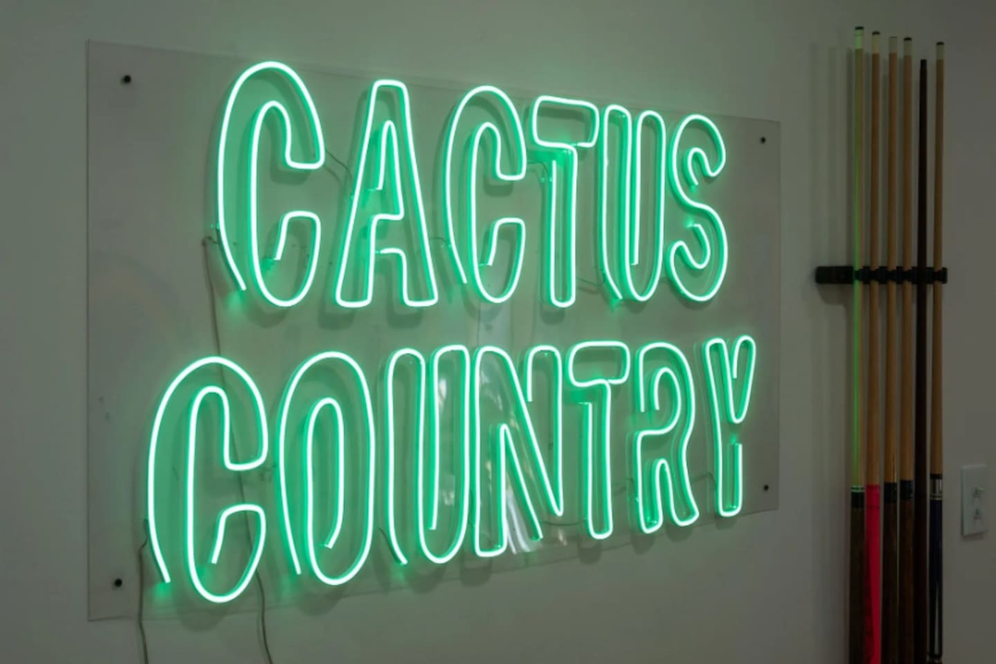 A glowing "Cactus Country" sign captures the playful desert spirit that runs through the whole home.
