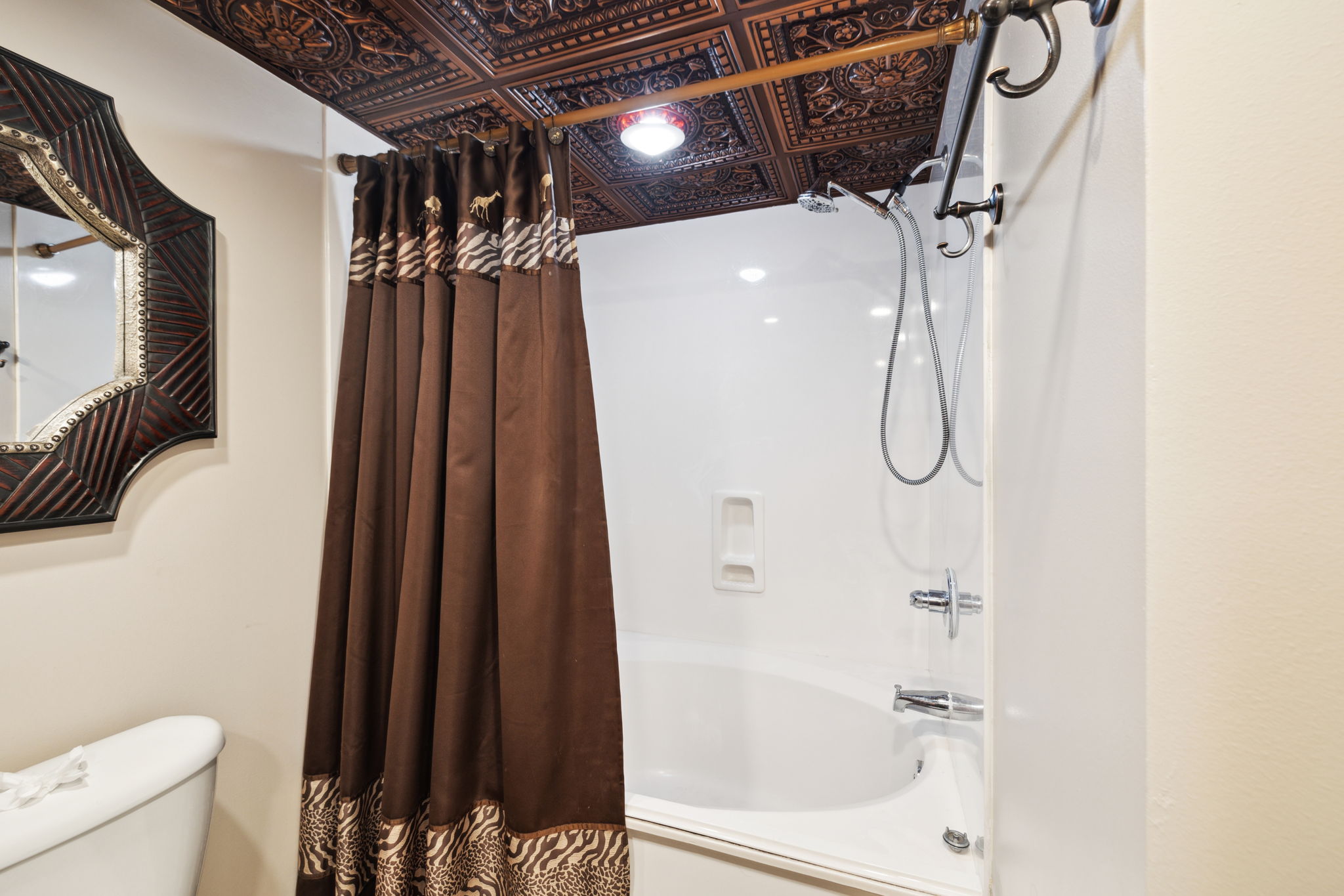En suite bathroom attached to the double queen bedroom includes shower / tub combo