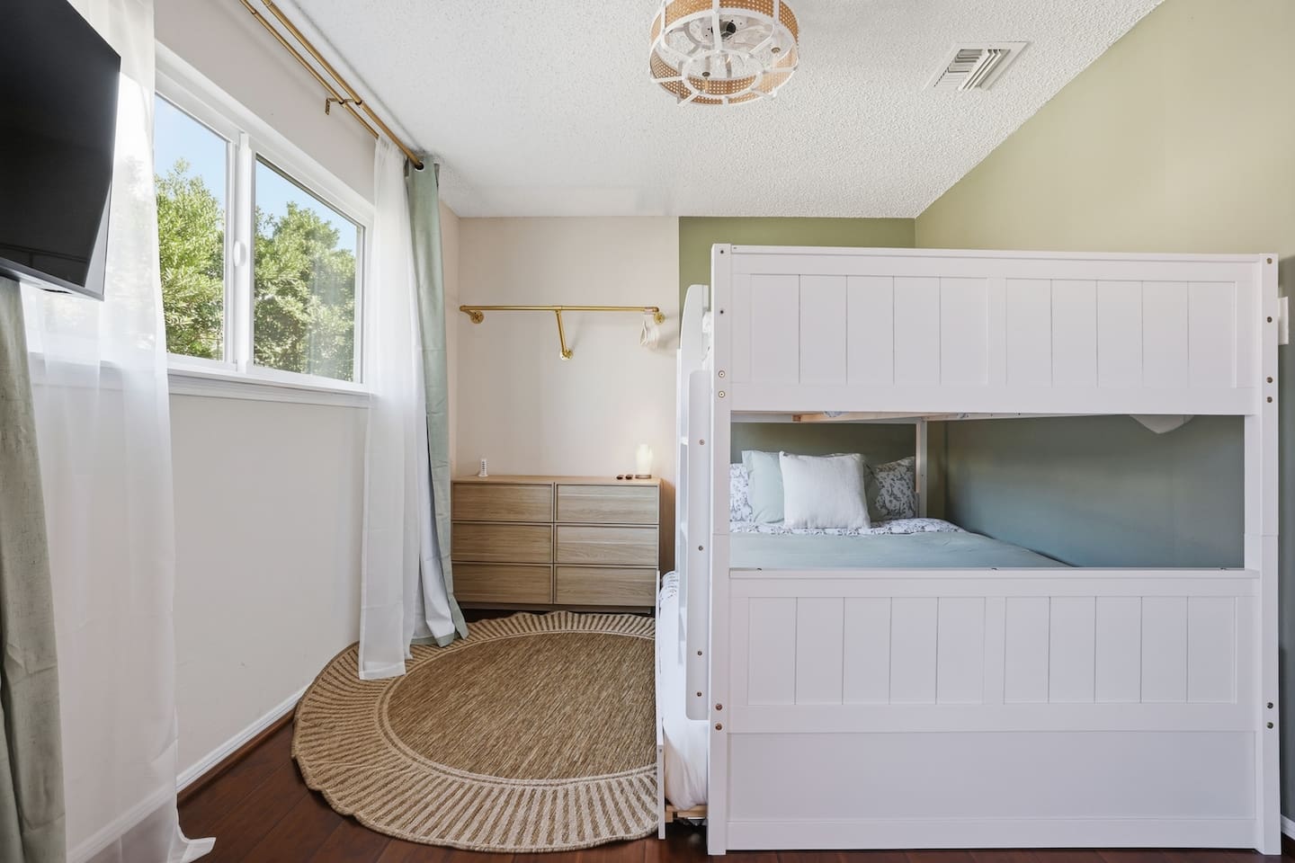 Spacious full-over-full bunk bed with twin trundle (lower bed suitable for toddlers). In-room TV and classic arcade game for entertainment. Includes dresser and closet space for easy storage. Changing pad available upon request