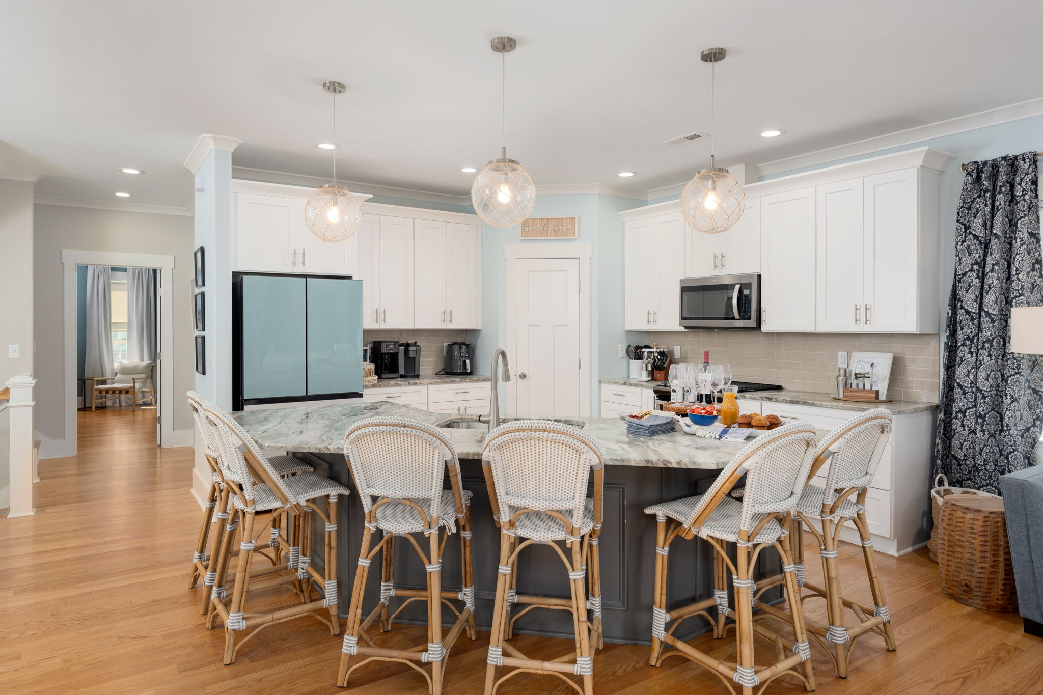 Bright, open kitchen designed for gathering, with a large island, bar seating, and plenty of room to cook and connect together.