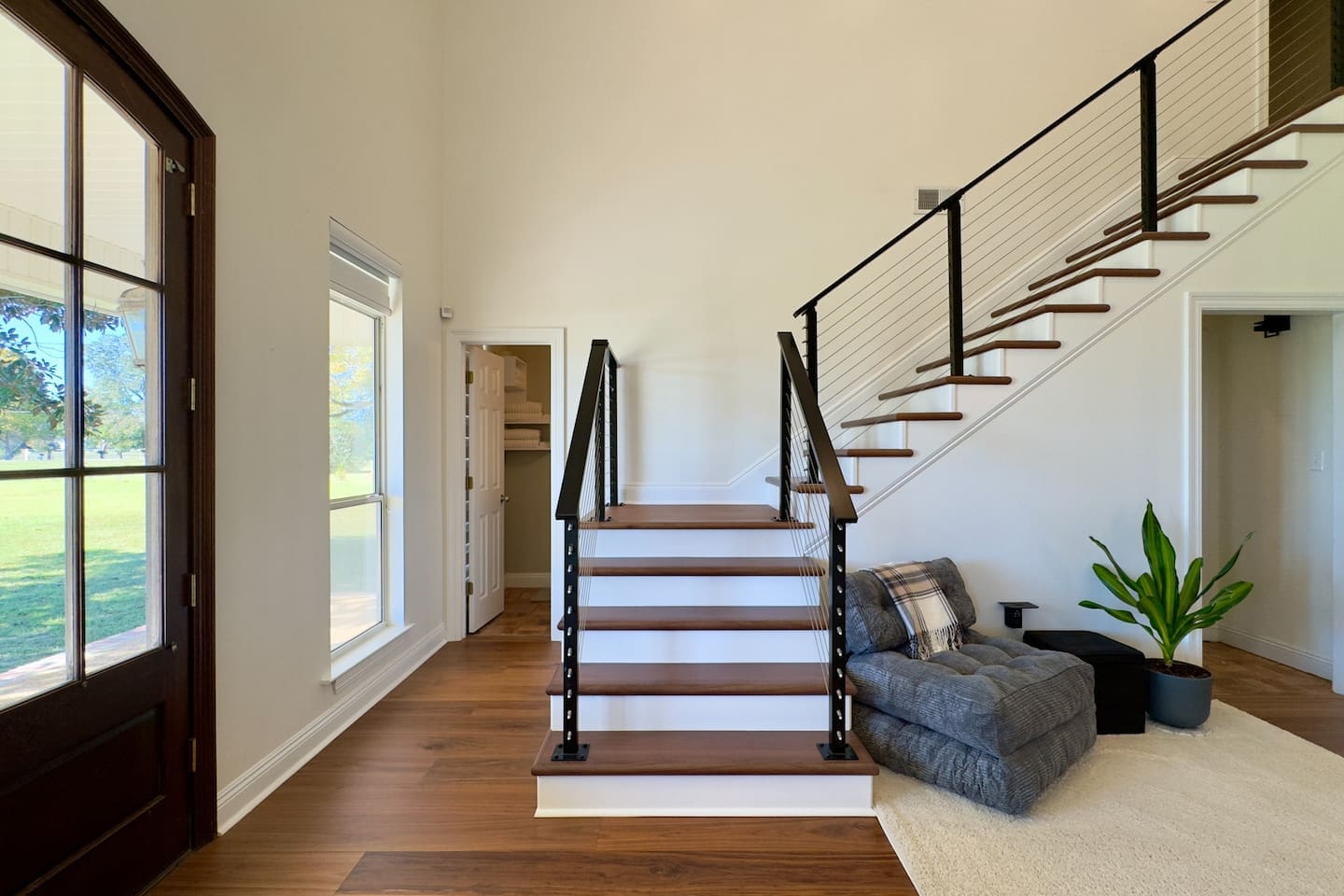 Dark wooden steps with sleek black railings create a striking architectural centerpiece.
