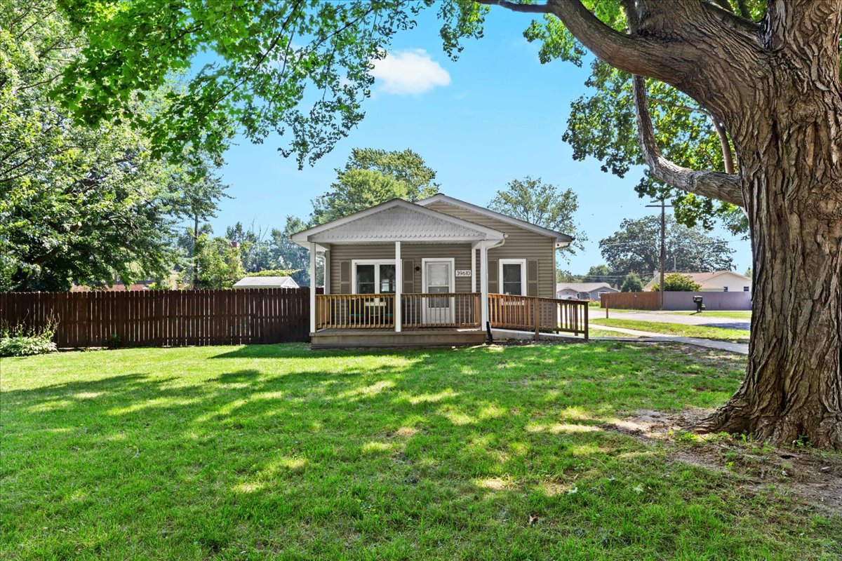 Large backyard with shade trees—perfect for relaxing