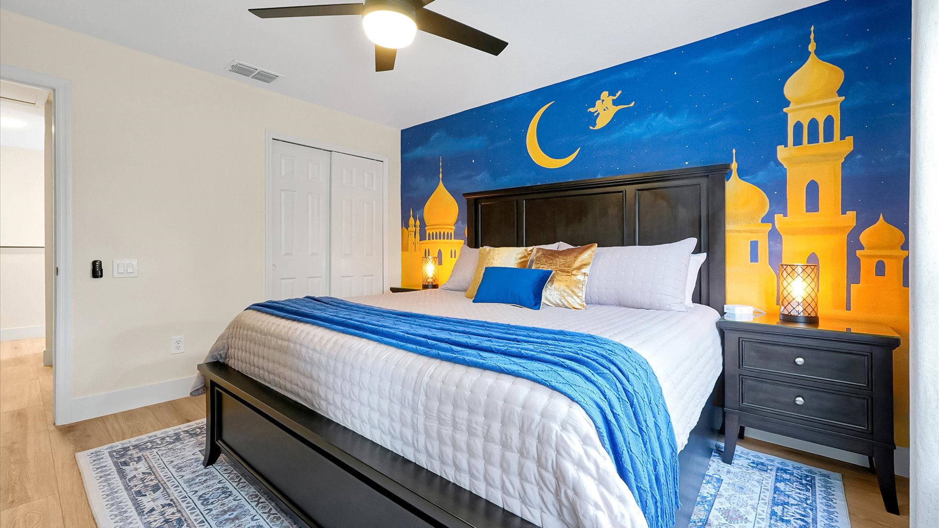 Aladdin King Suite: King bedroom with a hand-painted Agrabah palace mural, TV and ample storage.