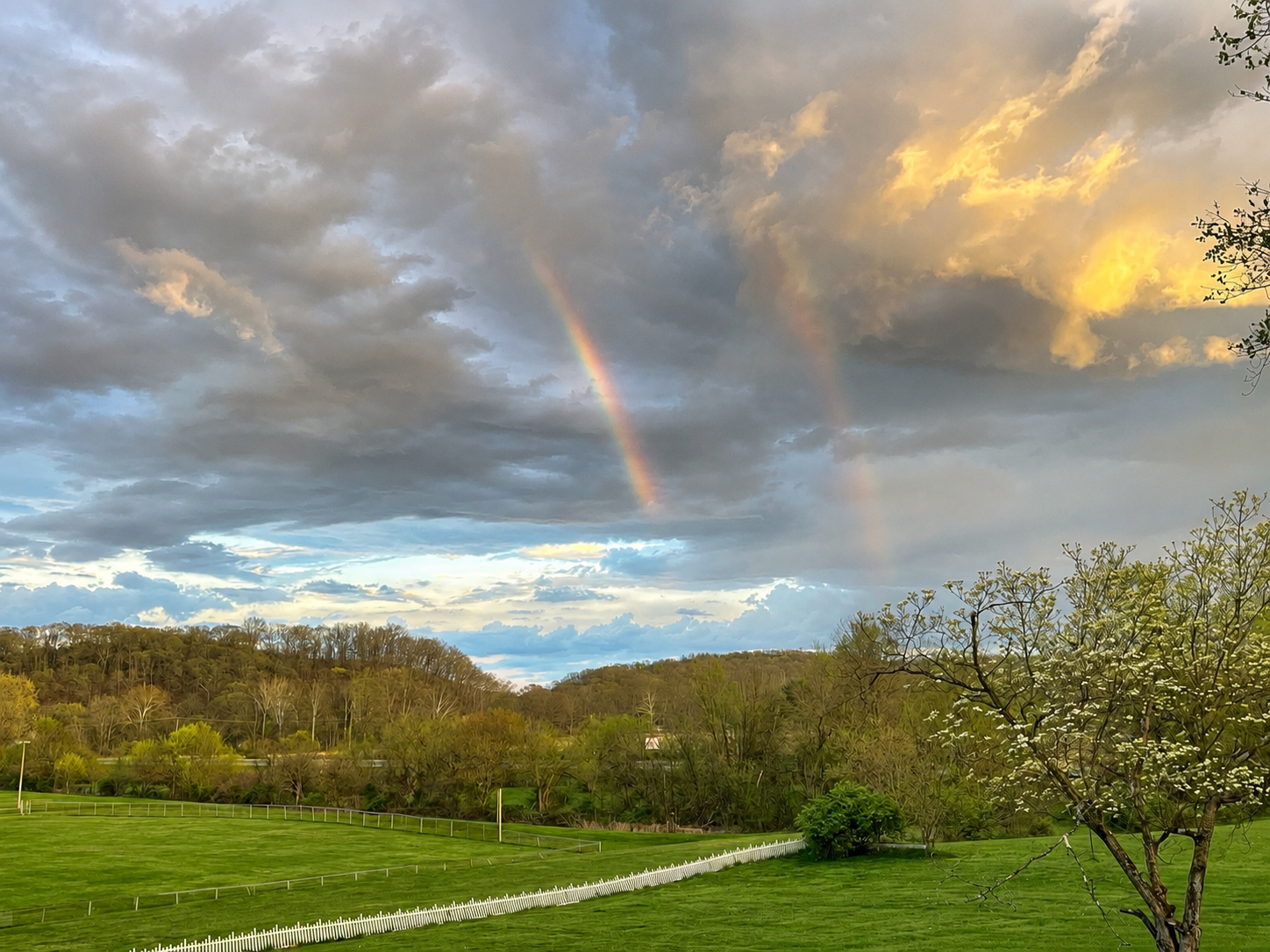 Double rainbow out the front porch overlooking the hill