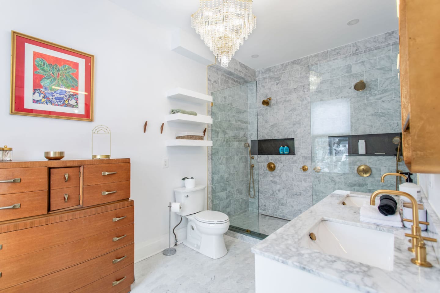 A full en-suite master bathroom, off of the master bedroom, equipped with a double shower, a toilet, and a double vanity with 2 sinks, providing all the essential amenities for elevated comfort and convenience. 