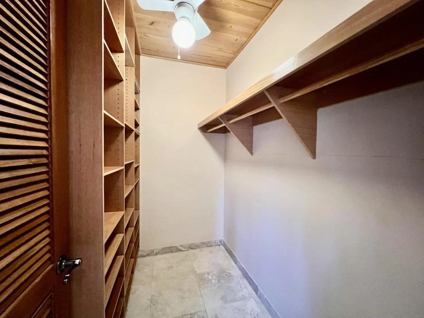 Spacious walk-in closet with built-in shelving—perfect for extended stays and unpacking.