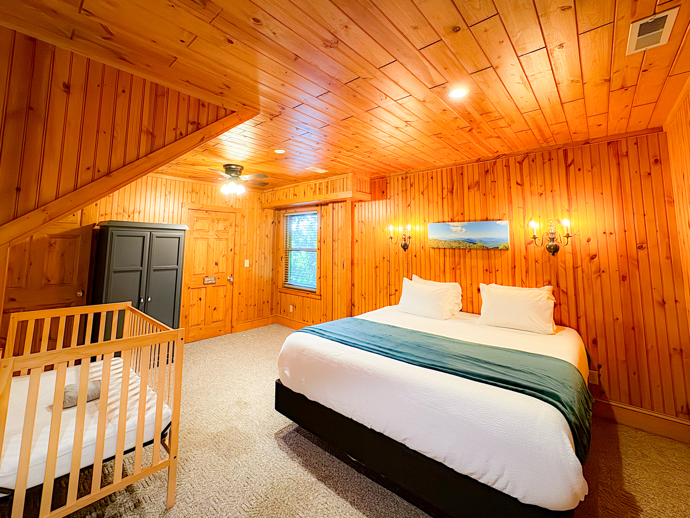 large bedroom one the lower level with a king bed, crib/pack-n-play, twin bed