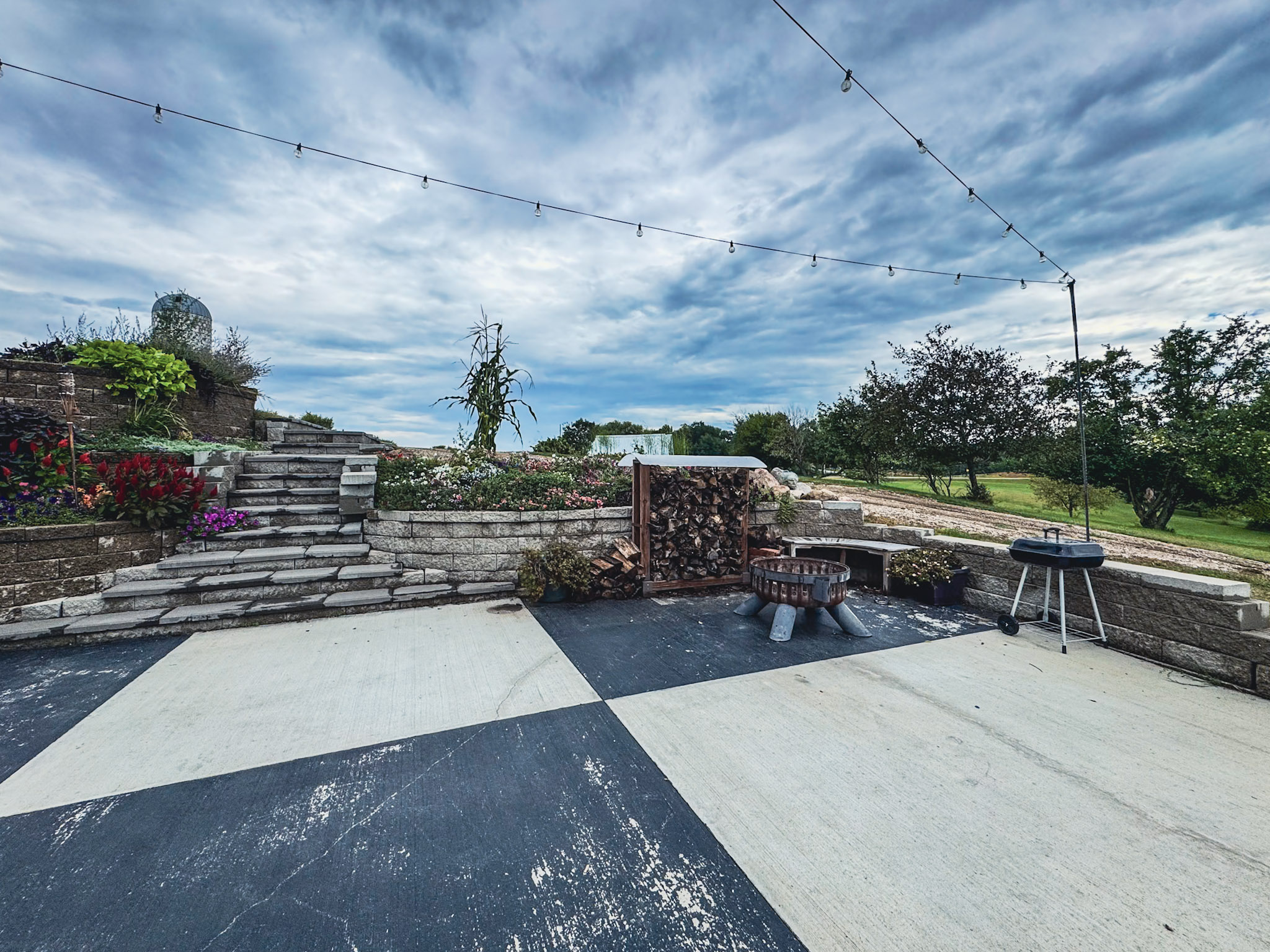 Patio fire pit and grill beside the landscaped steps.