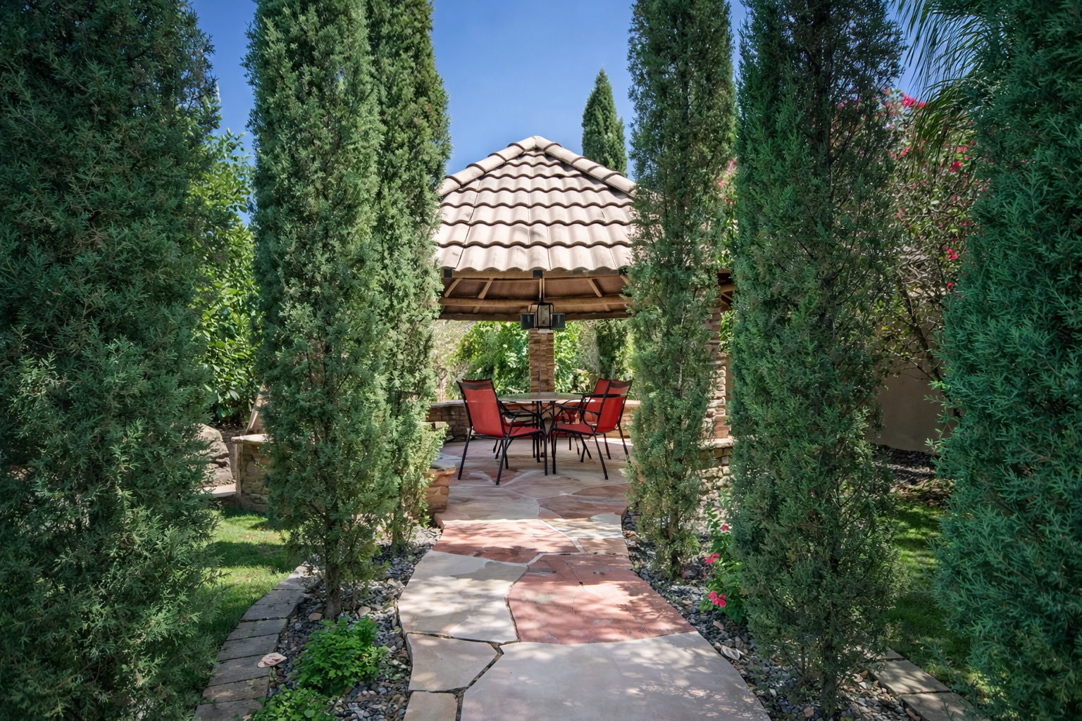 Stroll through lush greenery to a peaceful gazebo retreat, perfect for shaded dining, morning coffee, or quiet evening conversations.